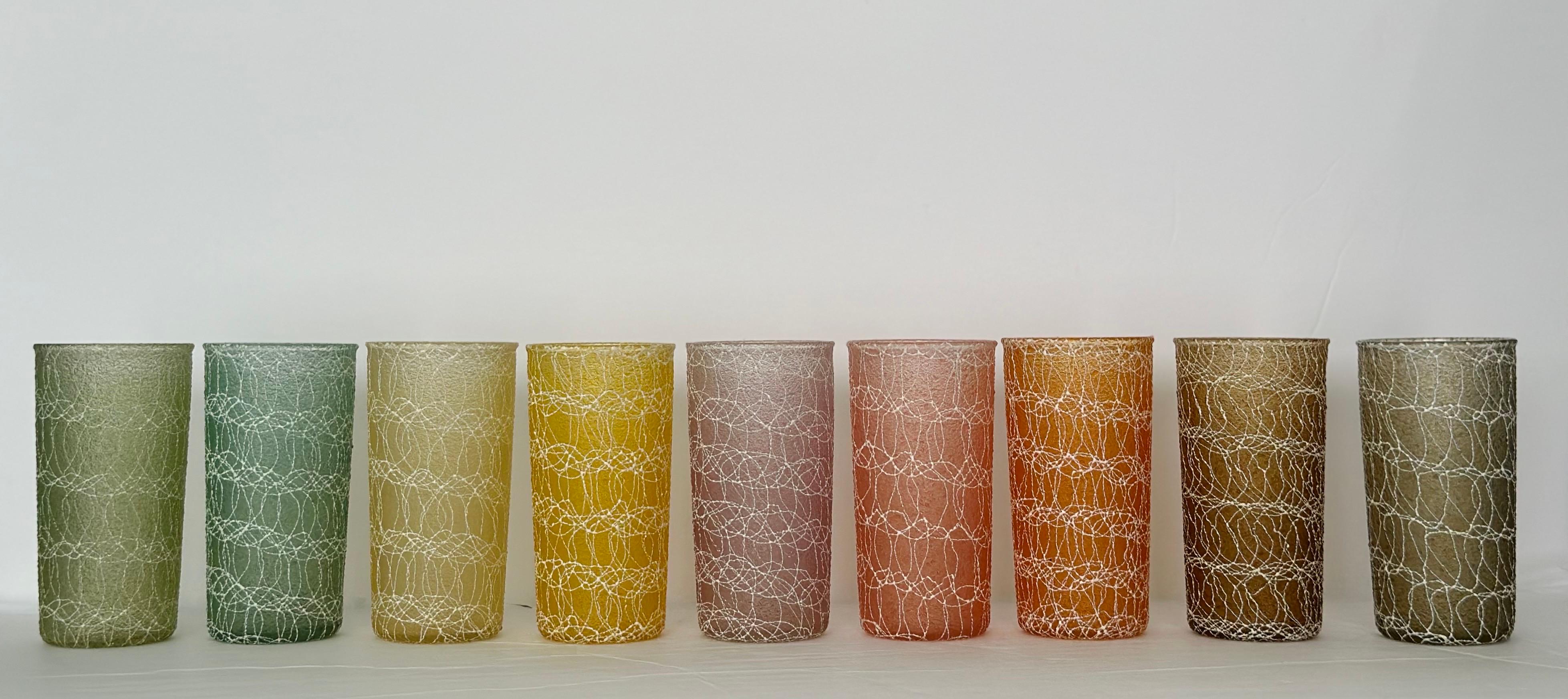 We are very pleased to offer a vintage set of nine spaghetti tumblers, circa the 1960s. This distinctive type of drinkware is characterized by their unique texture, which resembles strands or swirls of spaghetti.  Texture is created by applying