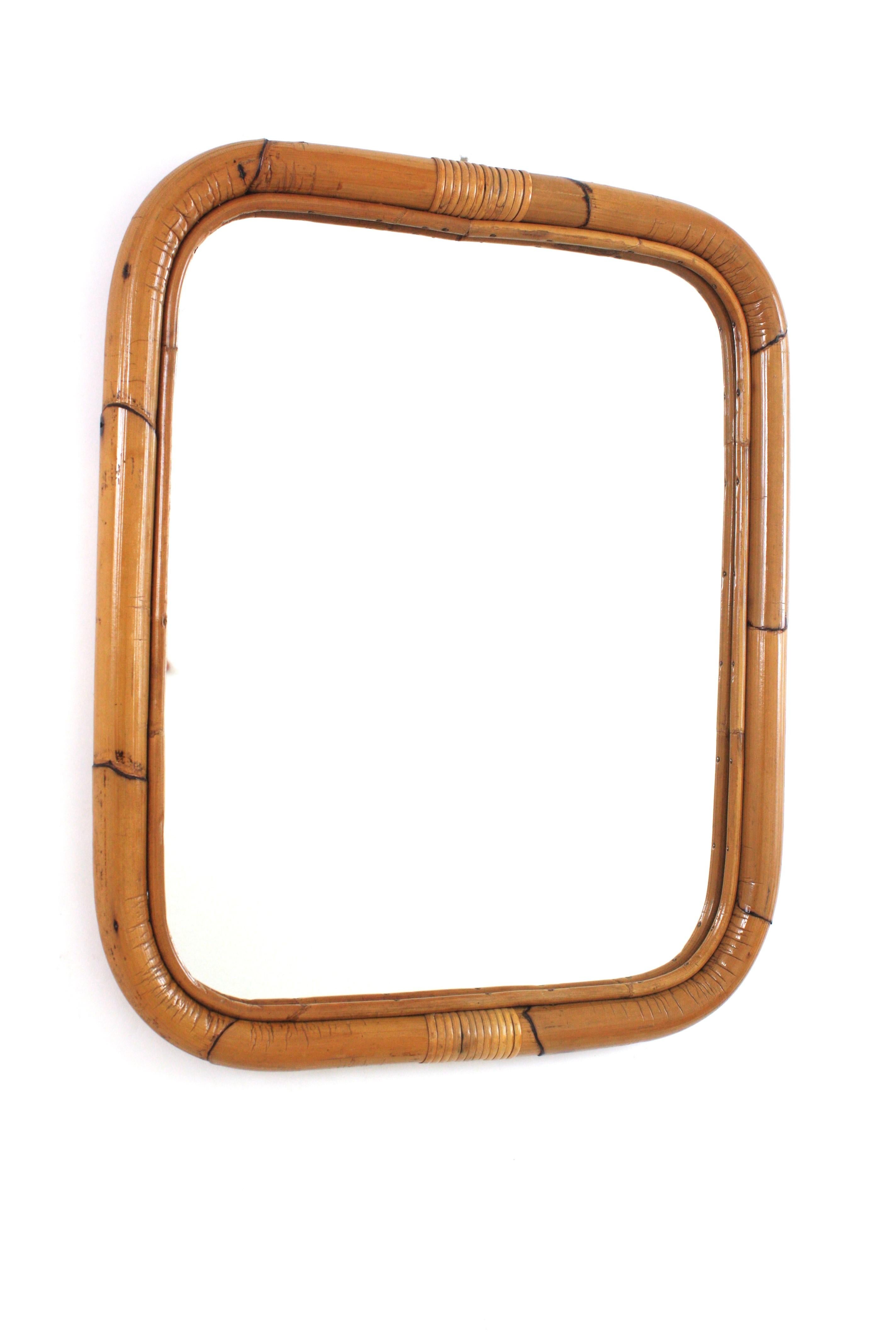 Rectangular wall mirror, bamboo, rattan
Eye-catching rectangular mirror handcrafted with thick rattan cane. Spain, 1960s.
Rectangular frame made of rattan with rounded corners. Wicker details at the top and bottom part.
This mirror is in excellent