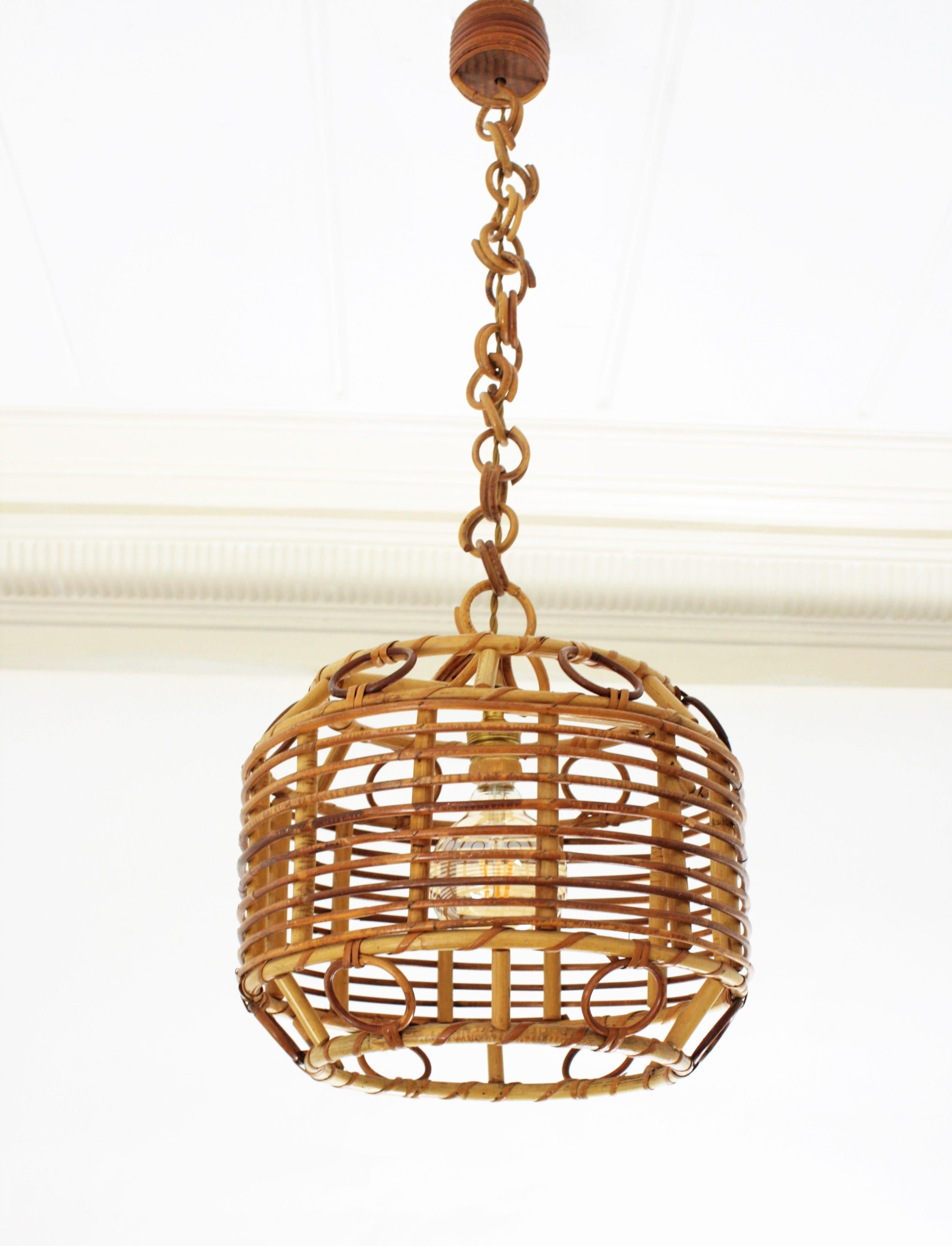 A beautiful handcrafted rattan, wicker and bamboo pendant light or lantern with geometric decorations, Spain, 1960s.
 It hangs from a wicker chain that can be modified to make it shorter. This lamp could add a fresh Mediterranean taste over a
