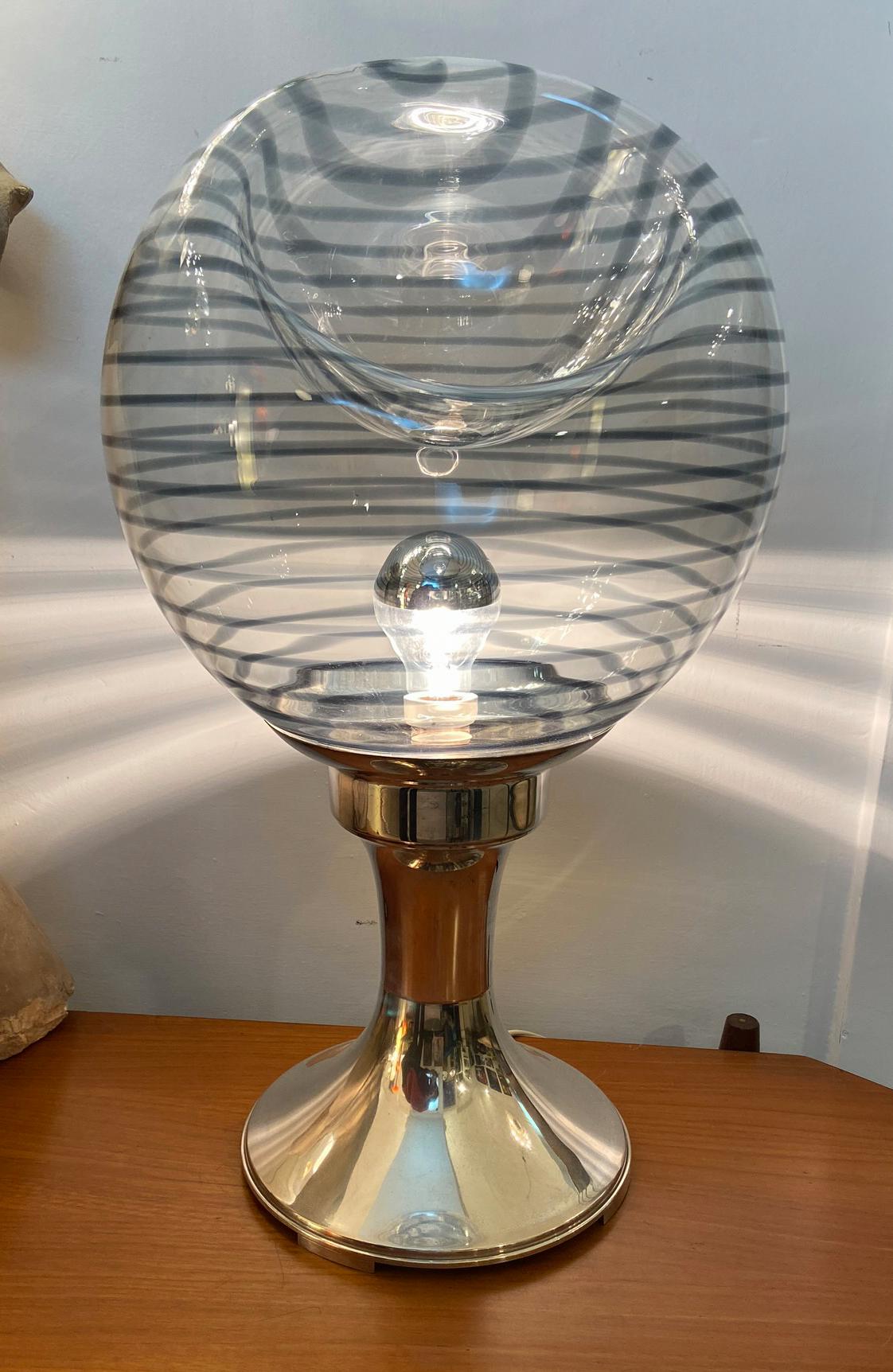 Very elegant table lamp formed by a large blown Murano glass ball, with dark stripes, on a pure silver base which weighs 1100 grams .