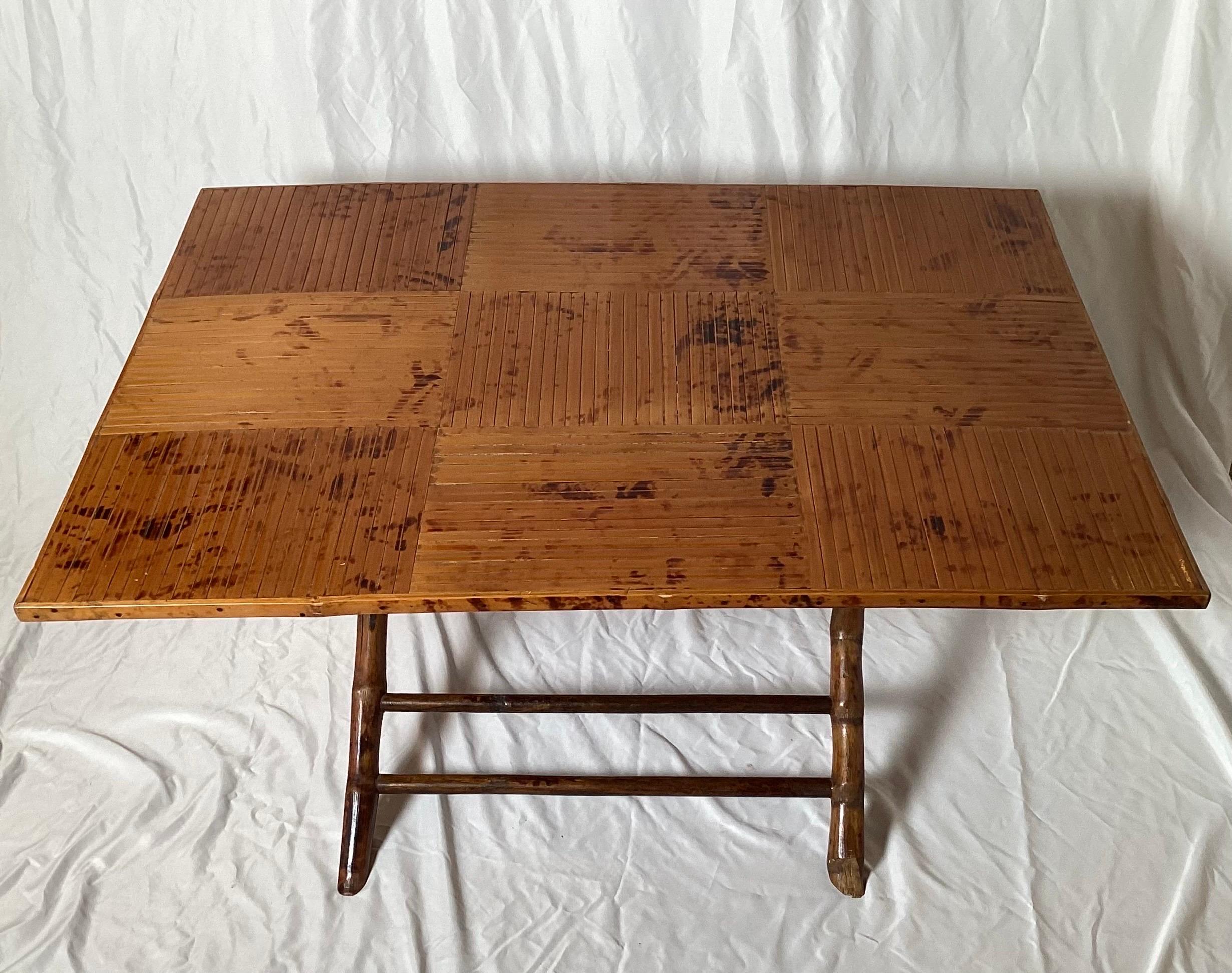 A beautiful split bamboo folding cocktail table, USA 1960's, the surface has been professionally polished, in excellent condition.  The table  measuring 17 inches tall, 36 inches wide, 26 inched deep when open, folded is 36 wide, 26 high 5 deep for