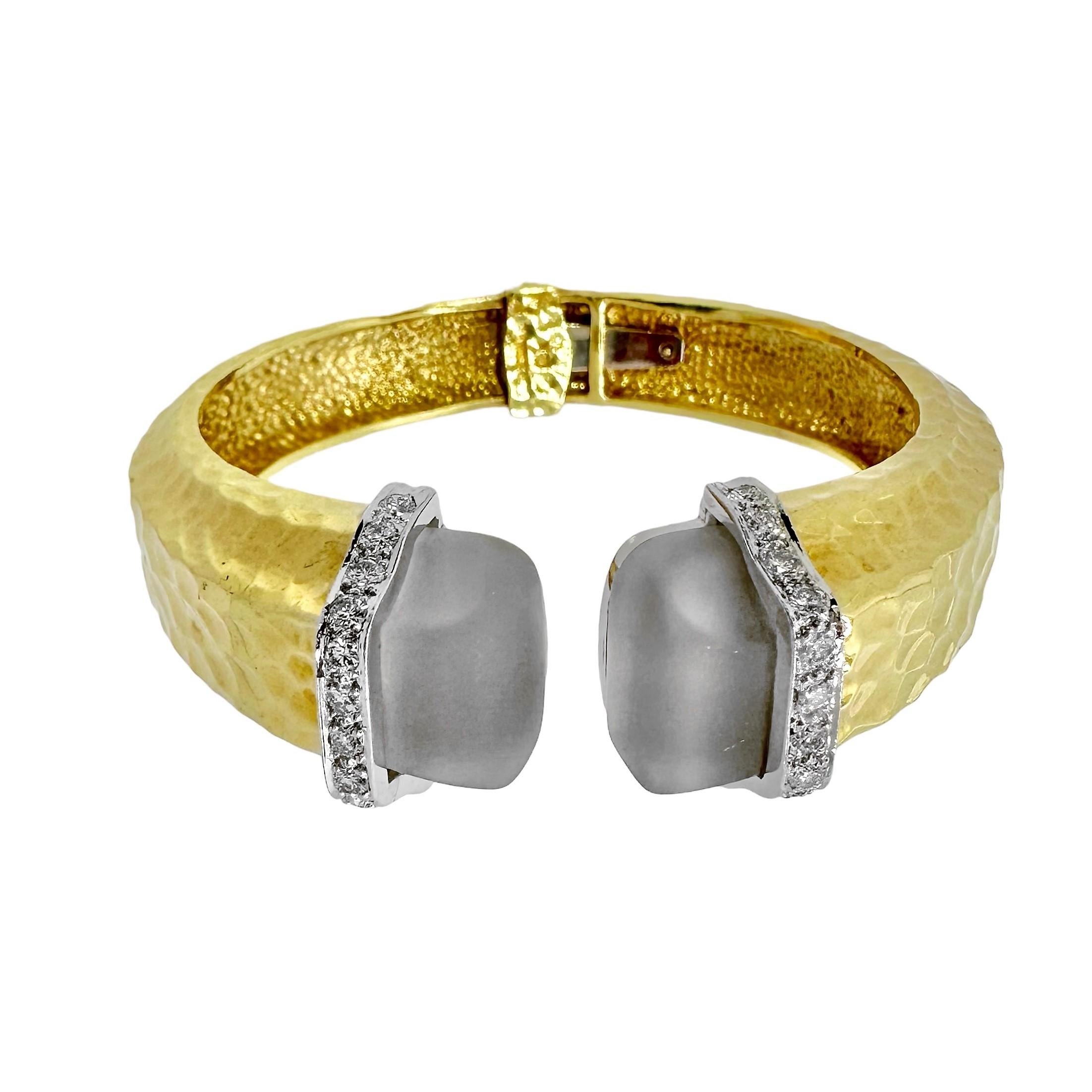 This substantial and Iconic vintage R. Stone original hinged 18k yellow gold bangle bracelet personifies pure 1960's high fashion. Every surface is deeply hammered and, at 7/8 inches in width, it is impressive to behold. Opening at the front, two
