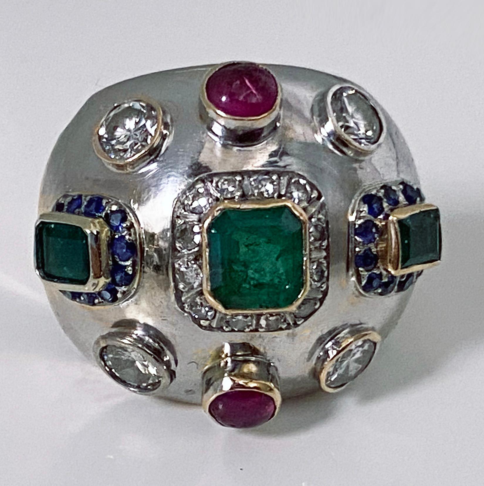 1960’s Sputnik gold diamond and gemstone ring. Set with three yellow green rectangular set emeralds, approximately 3.00 ct, total weight, average SI1 (type 111) clarity, four round brilliant cut diamonds, approximately 1.00 ct, total diamond weight,