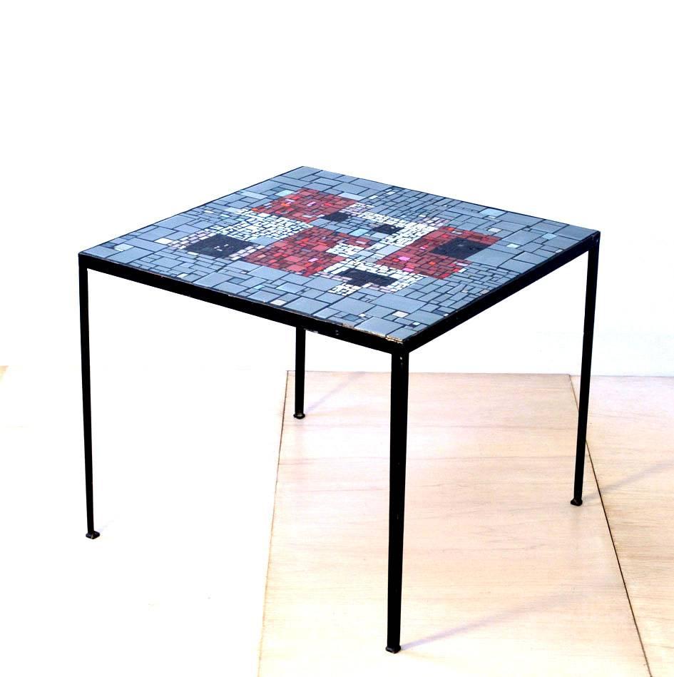 Square mosaic side table is like an abstract, 1960s painting. The linear black metal frame draws the attention to the colorful and detailed mosaic tabletop with abstract design in vibrant red, black and white glass.