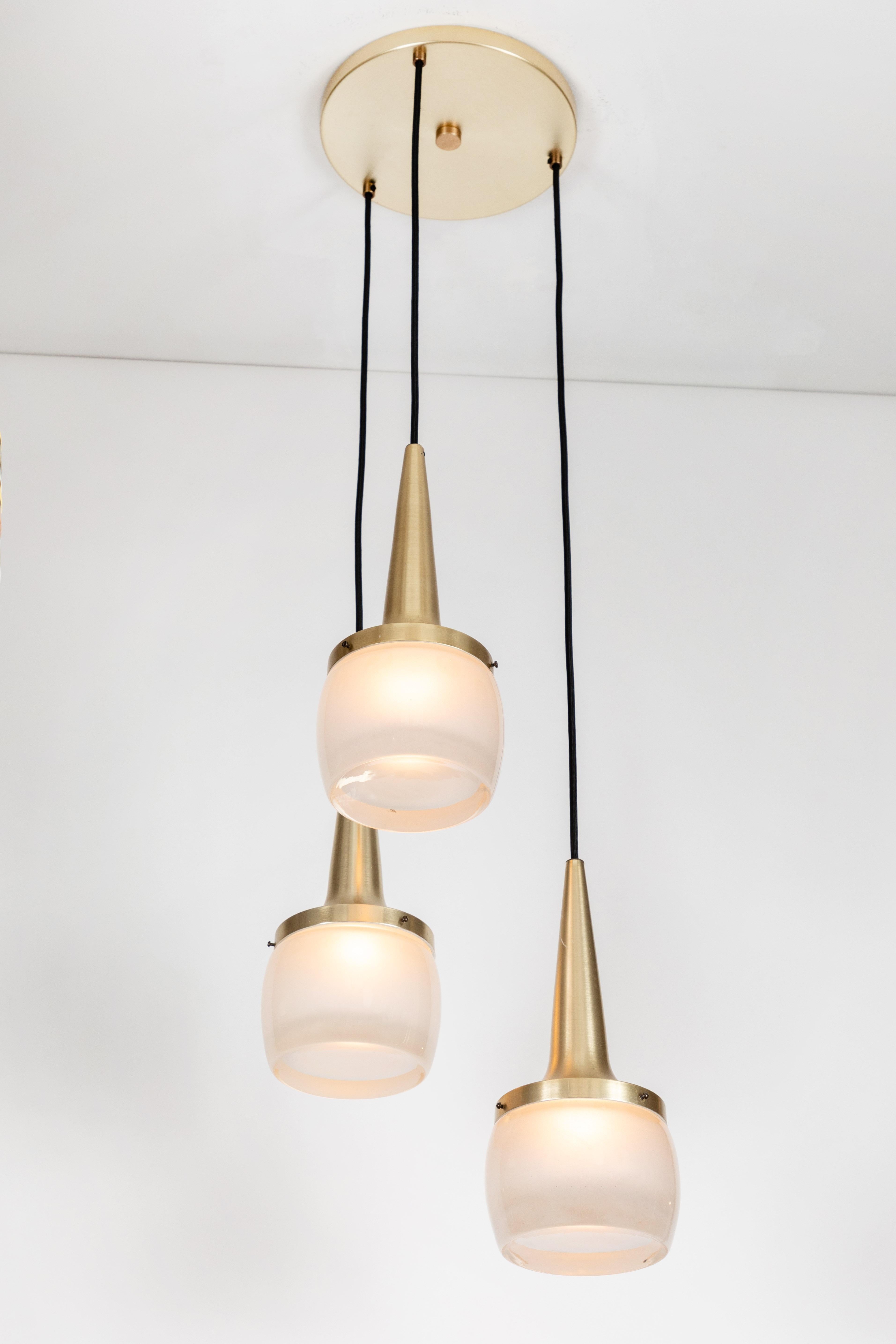 1960s Staff Leuchten large pendant chandelier. Executed in brushed nickel brassed metal and thick opaline molded glass etched on the inside, with brass canopy and thick cloth cord, Germany, circa 1960s. Each individual pendant measures 13.5 in.
