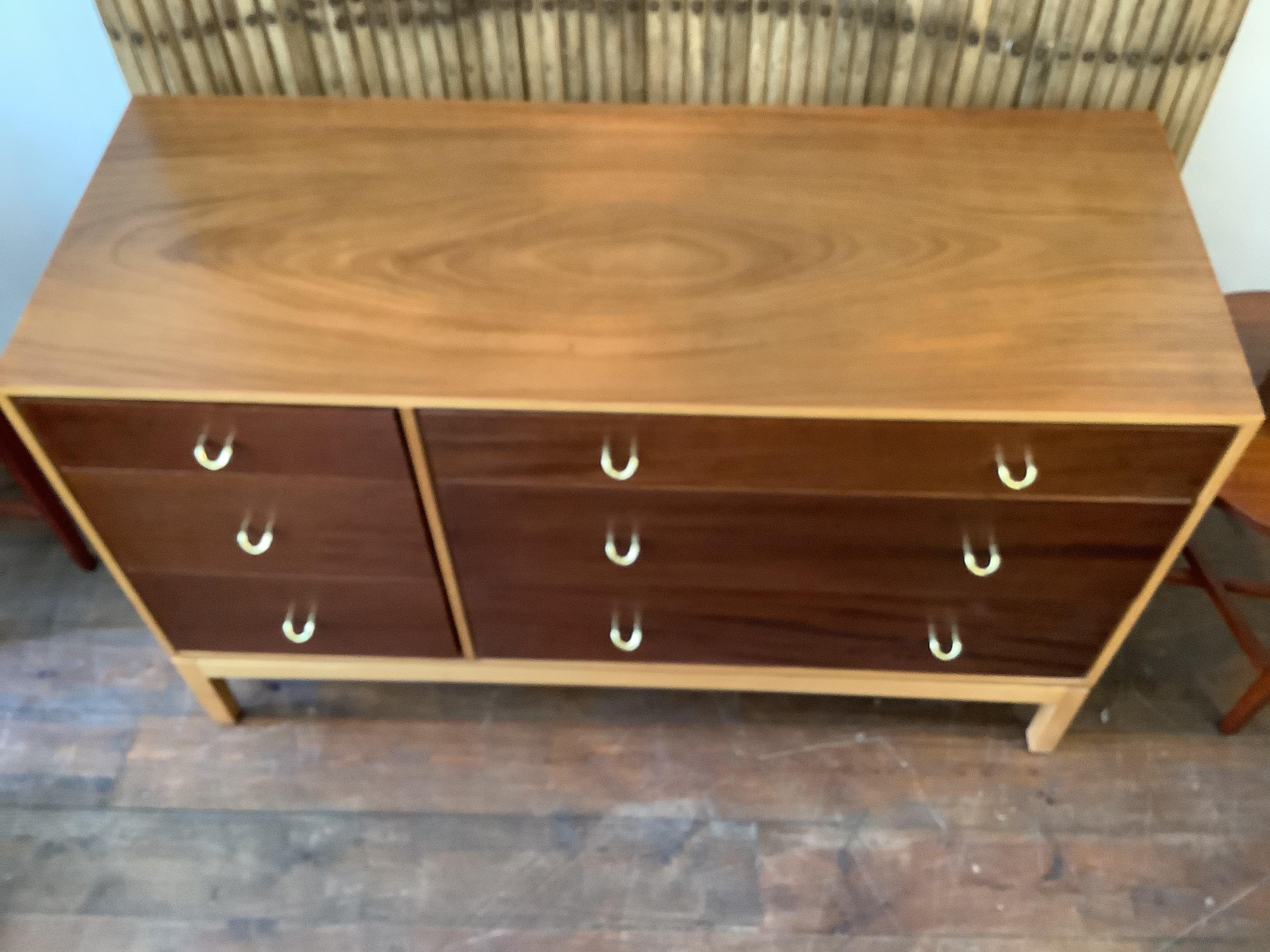 Mid century chest of drawers.
Designed by John & Sylvia Reid for Stag Furniture.
Two toned teak wood in colours dark brown and light brown.
Featuring real brass handles and a range of drawer compartments in various sizes.
Ideal for Minimalist