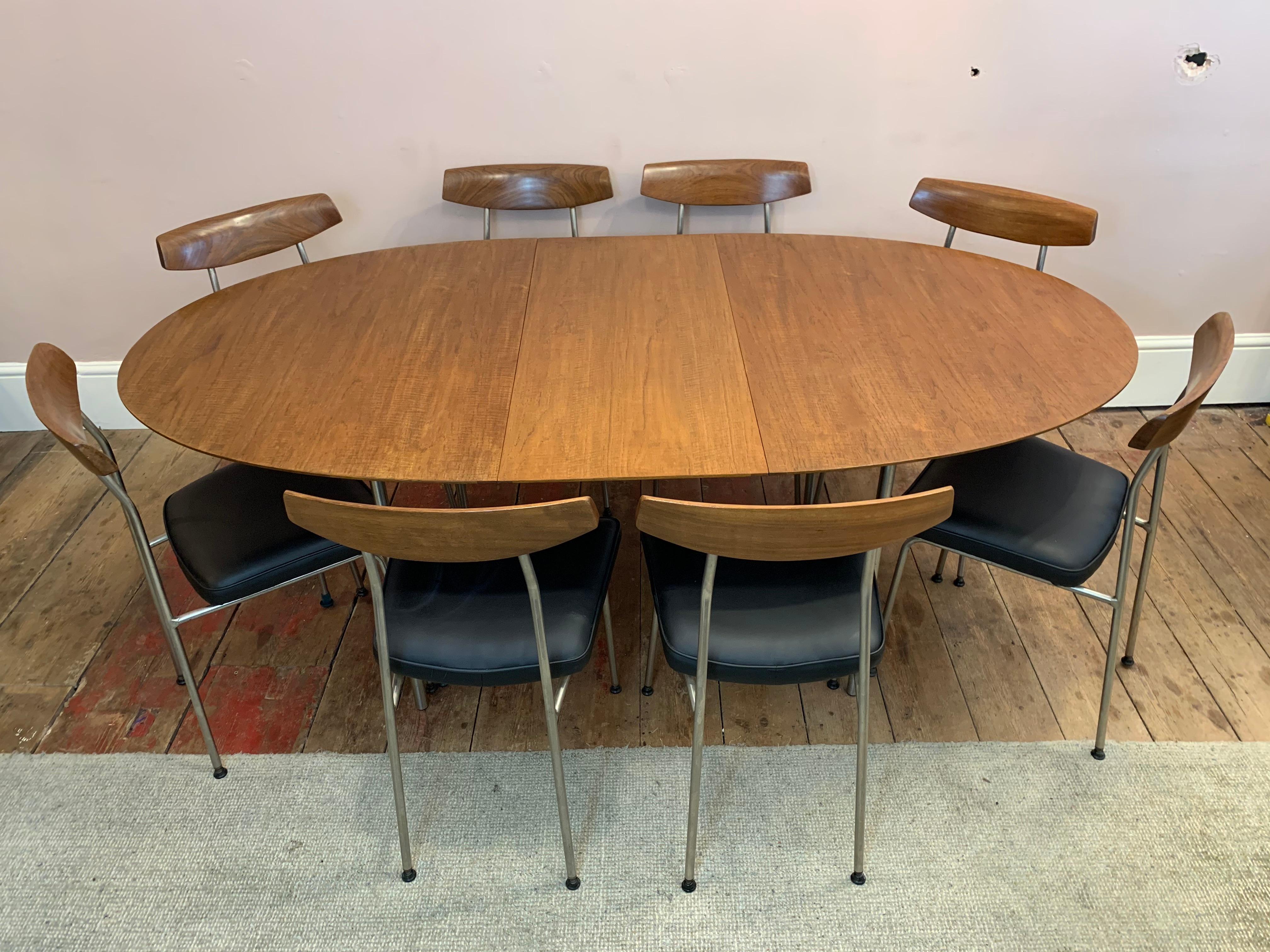 1960s midcentury 'S' range teak oval extending dining table designed by husband and wife team, John & Sylvia Reid, for Stag Furniture which also includes eight original model S230 dining chairs.

The table and chairs have been professionally