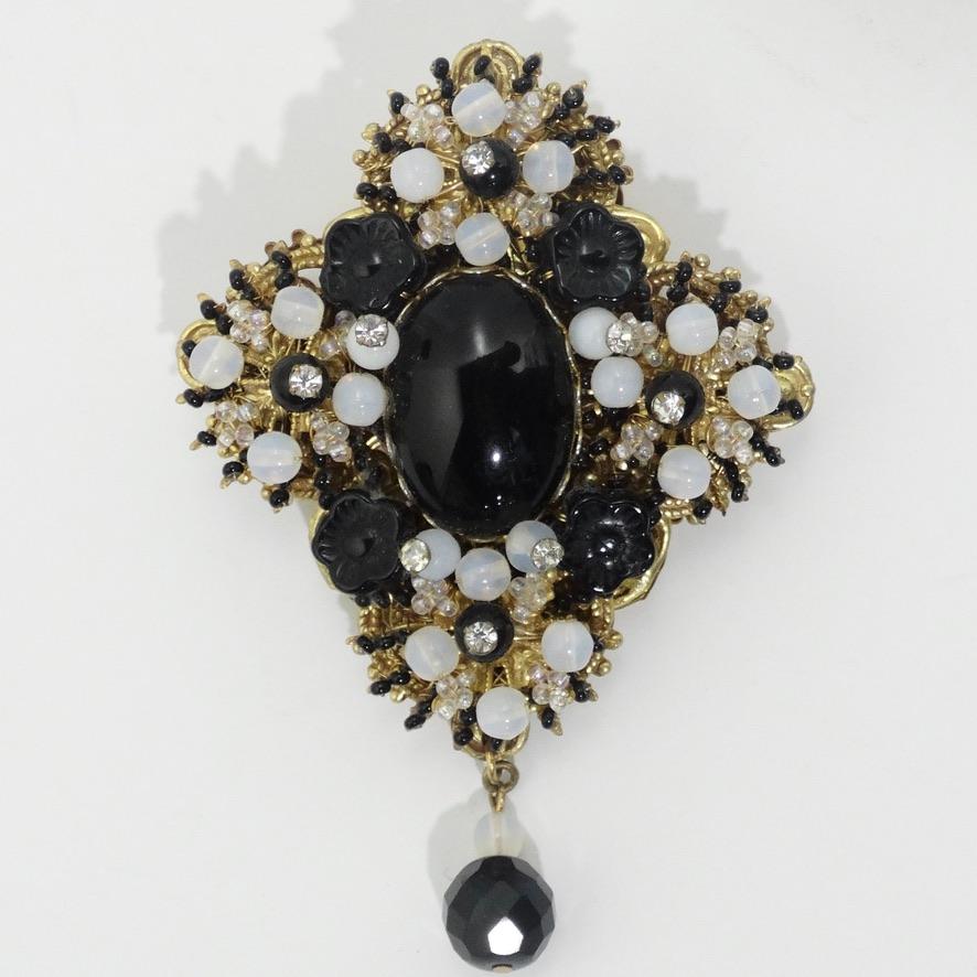 Gorgeous vintage Stanley Hagler NYC brooch circa 1960s! A cluster of black, white and silver beads surround a black moonstone in the center with solid gold accents as the finishing touch. The glamorous yet classic look of this brooch will never go