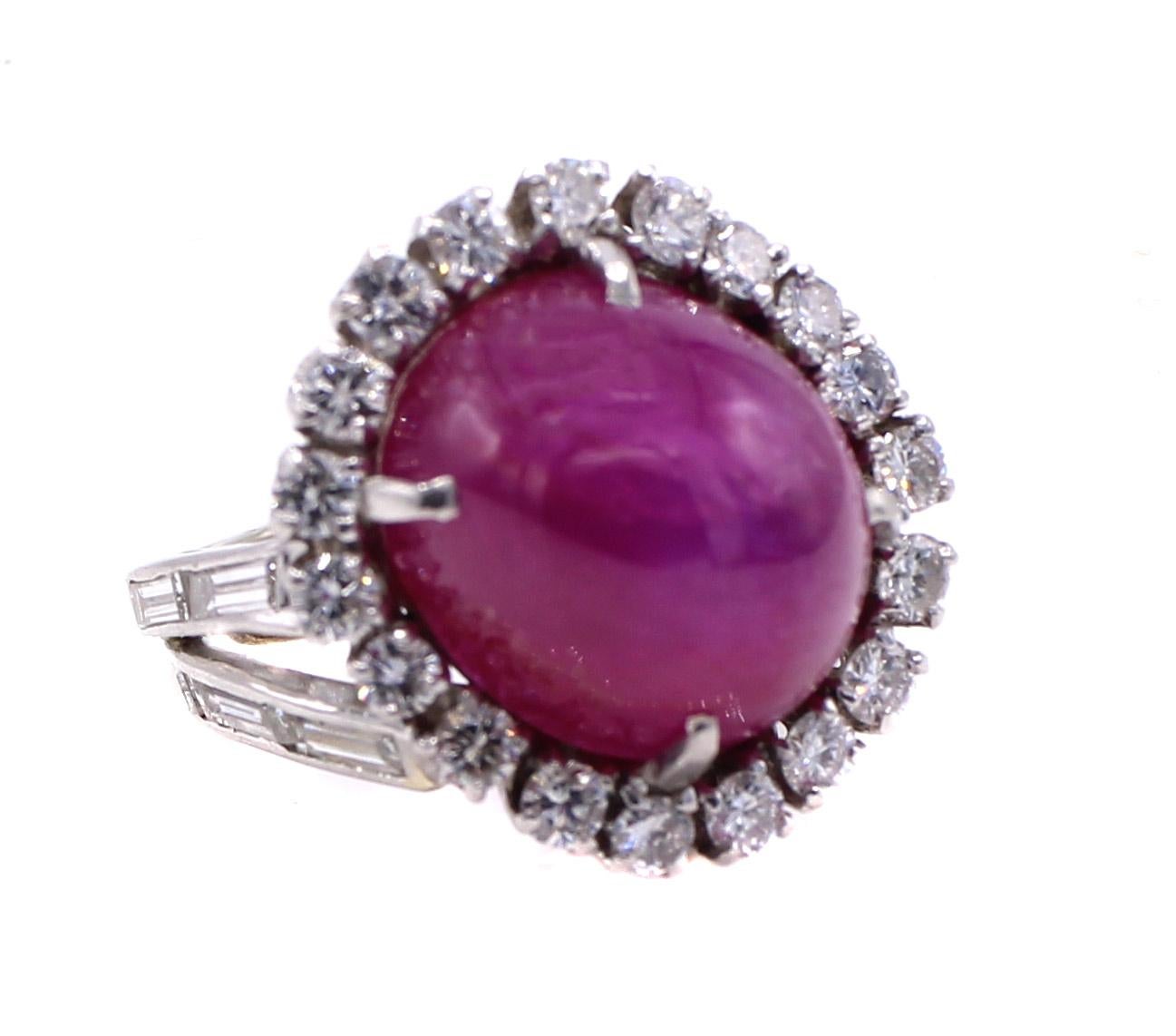 The centerpiece of this beautiful 1960s cocktail ring is a cabochon star ruby measured to weigh approximately 16 carats. When hit by direct light one can see the star move across the surface of the ruby. The masterfully handcrafted platinum setting