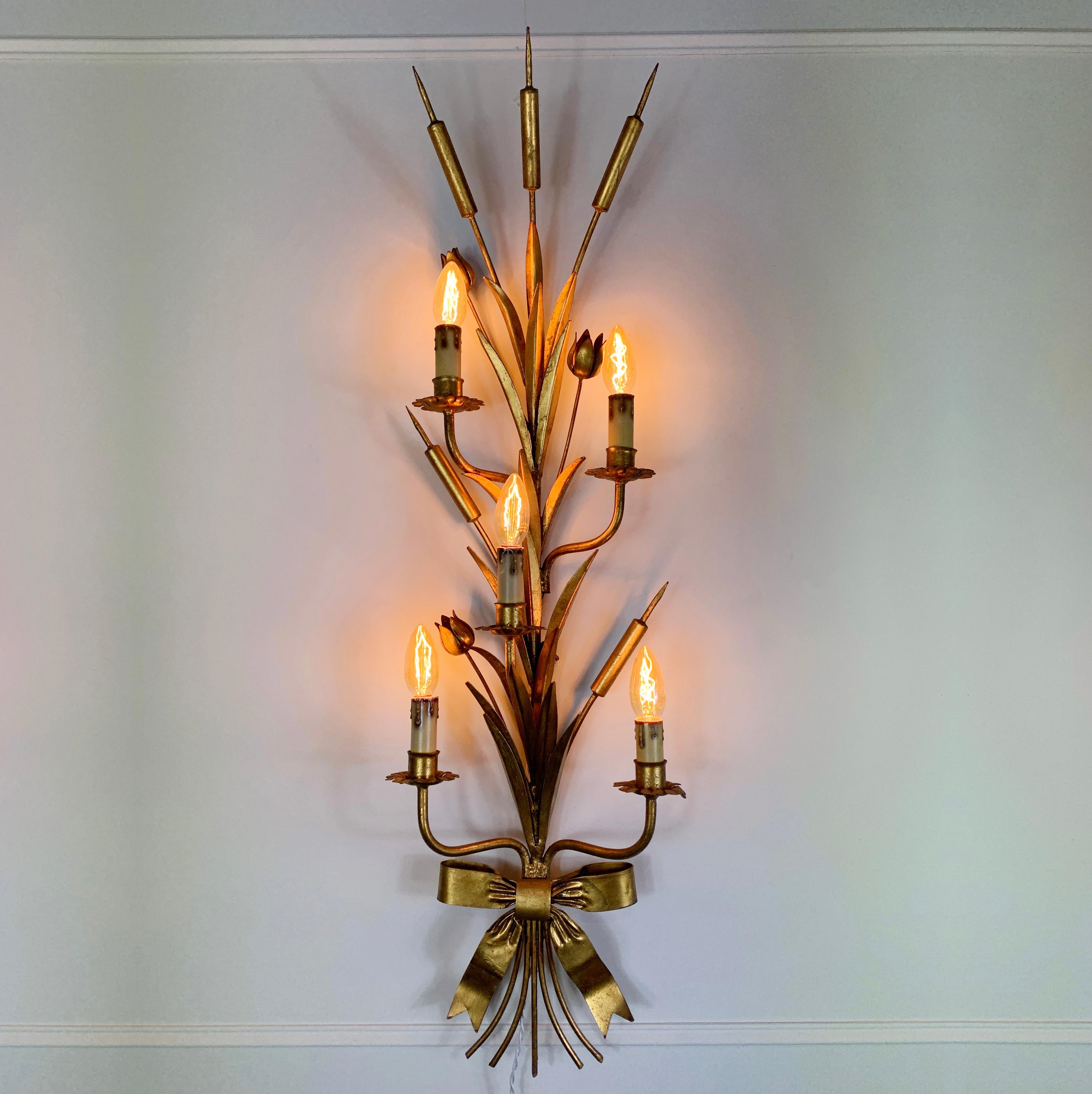 Large statement bulrush design wall sconce
Gilt metal leaves, metal flowers and bulrush stems decorate the impressive wall sconce

Mixed between the flowers and leaves are 5 arms, each with a bulb holder
The lamp takes E14 small screw in bulbs x