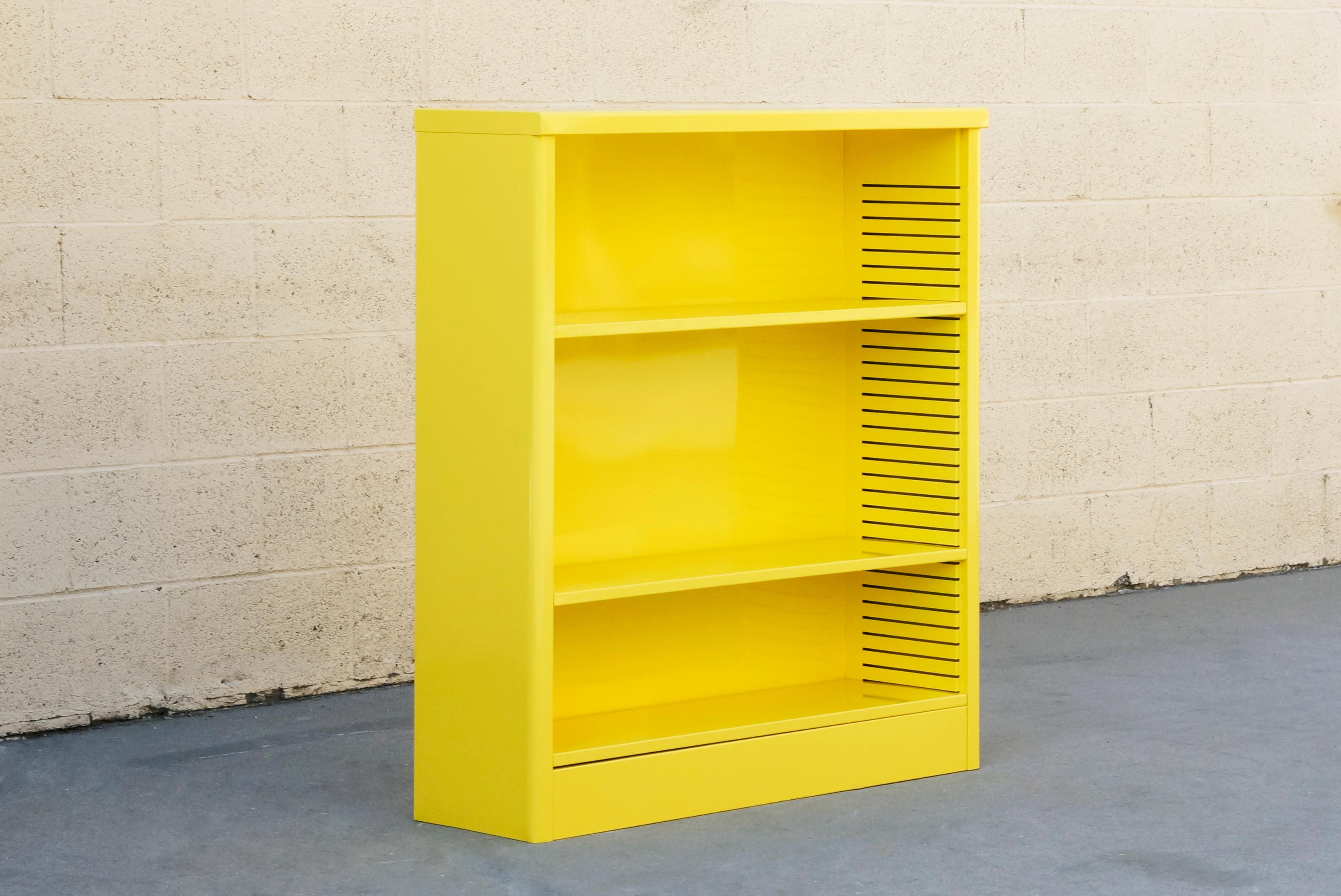 Neat 1960s tanker style steel bookcase freshly powder coated in high gloss Mellow Yellow (YL01). Originally used in the UCLA math department, this adjustable three-shelf unit is an excellent storage option– its sleek and compact, yet holds many