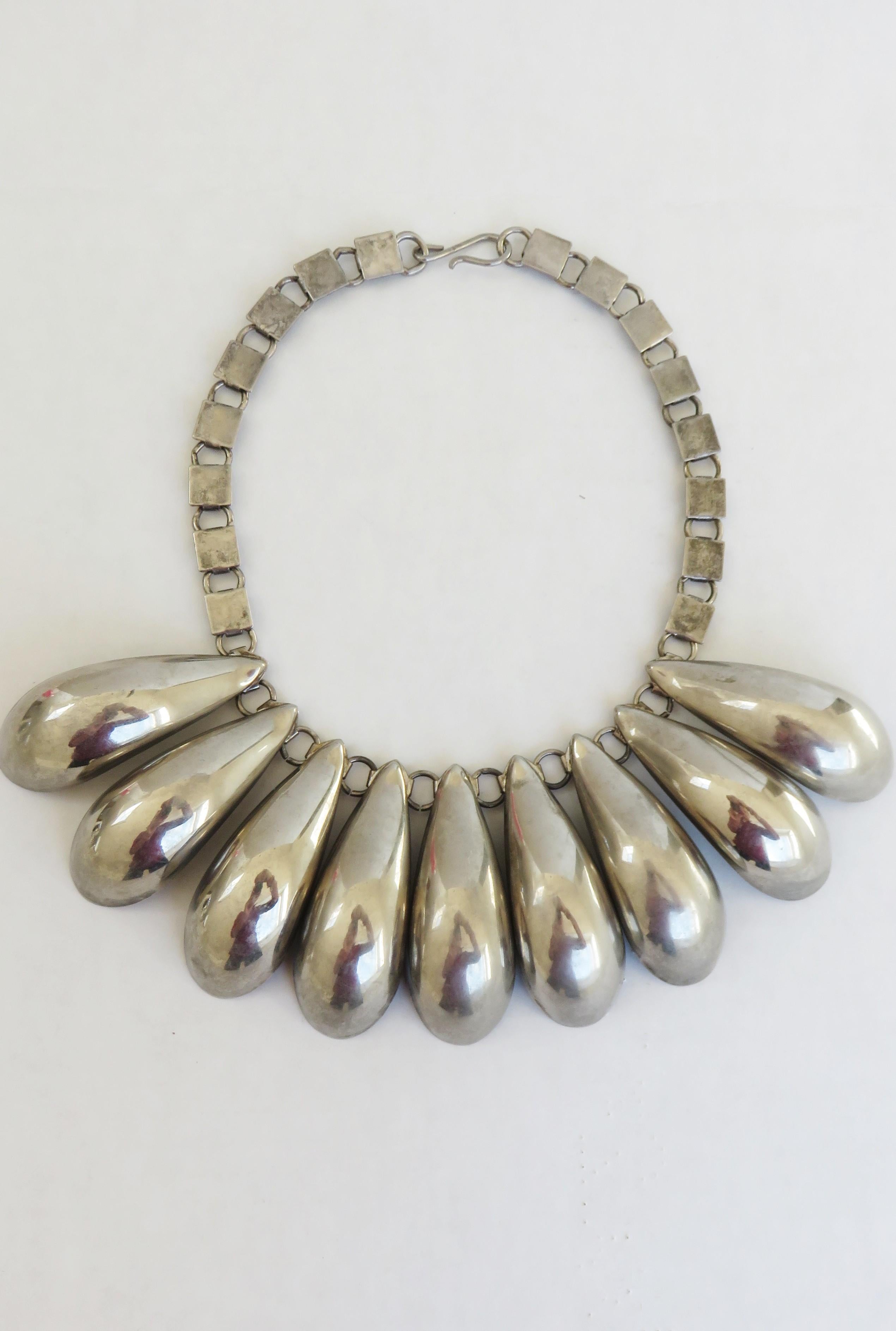 A stunning silver steel drop necklace. It has a box chain and 9 2