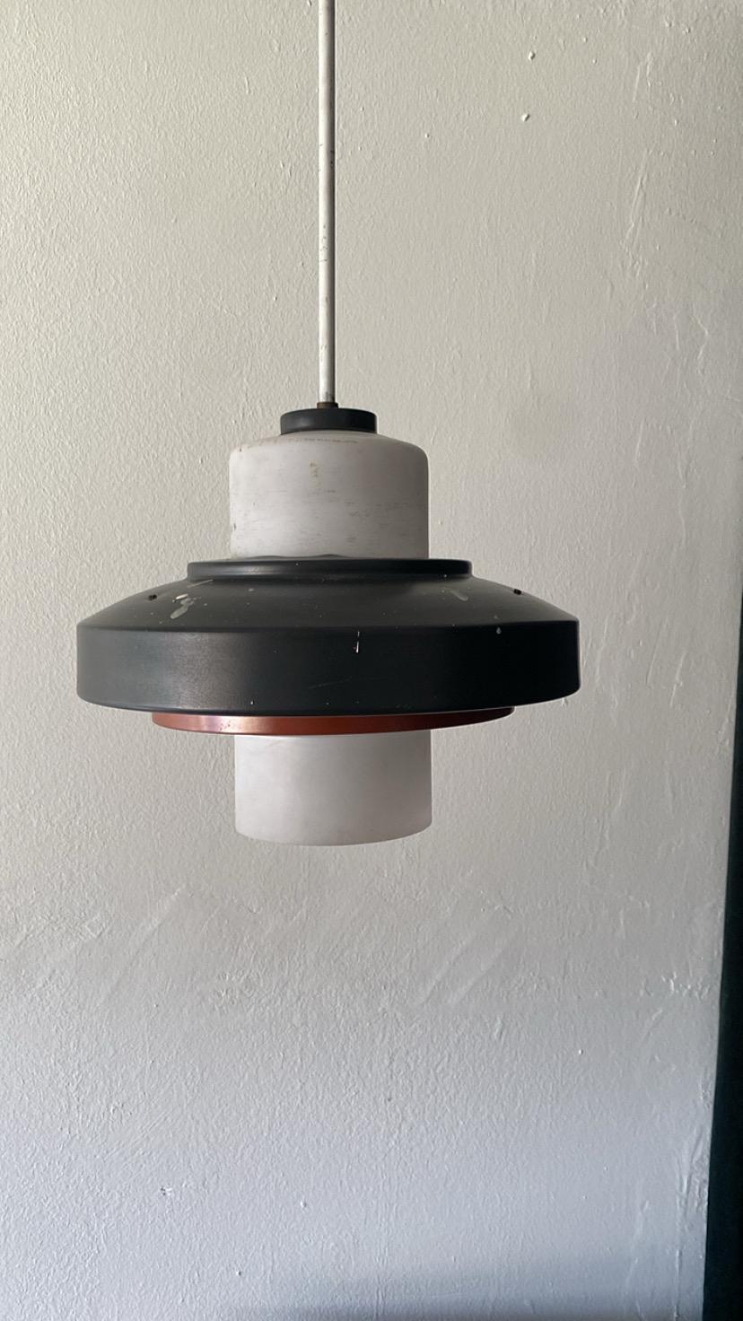 Stilnovo ceiling pendant. Manufactured in the 1960s made of opaline glass and metal. Corded is enclosed in a metal rod but can be changed out for a fabric cord. Has one medium base socket/ drop can be made longer or shorter