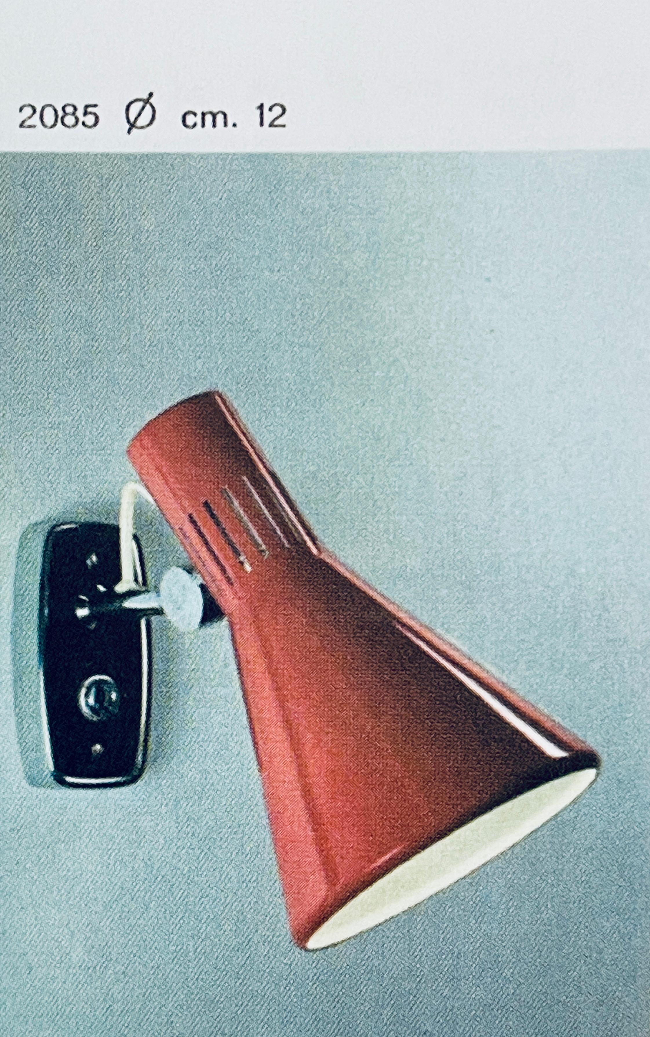 1960s Stilnovo Model #2085 articulating wall lamp with original yellow label a quintessentially 1960s Italian design executed in red painted metal with modified Italian backplate for mounting over a standard American j-box. Shade can be rotated