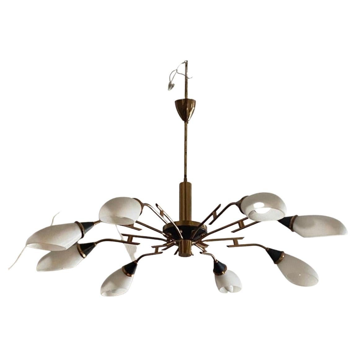 A Mid-Century Modern six lights chandelier designed and manufactured in Italy in the sixties it's a beautiful and iconic piece of lighting that embodies the clean lines, elegant simplicity, and functional design of Mid-Century Modern style.
The