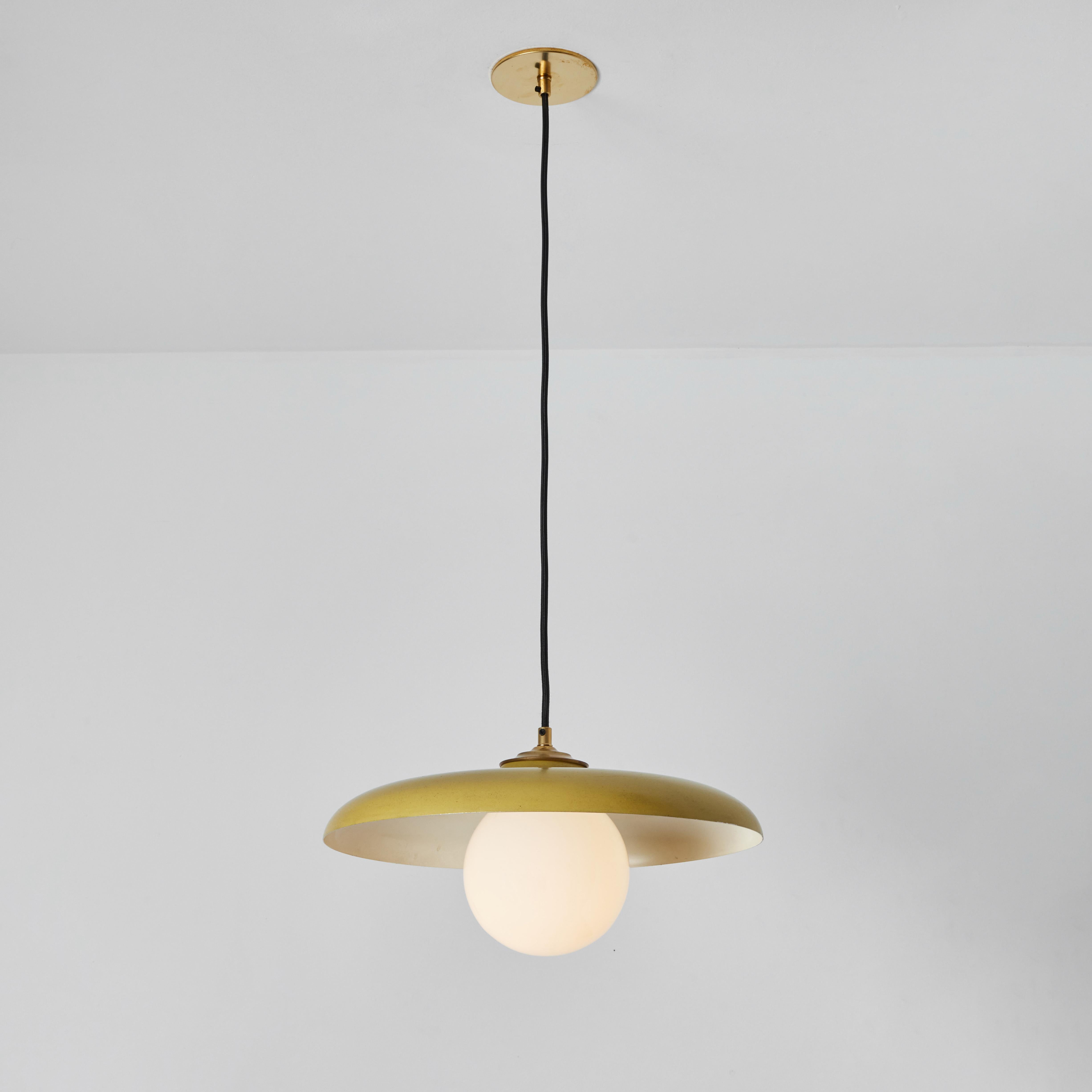 1960s Stilux Milano yellow painted metal & opaline globe glass pendant lamp. Executed in yellow painted metal, opaline glass and brass with thick cloth cord that can be cut to desired length. 

Stilux was one of the most innovative lighting design