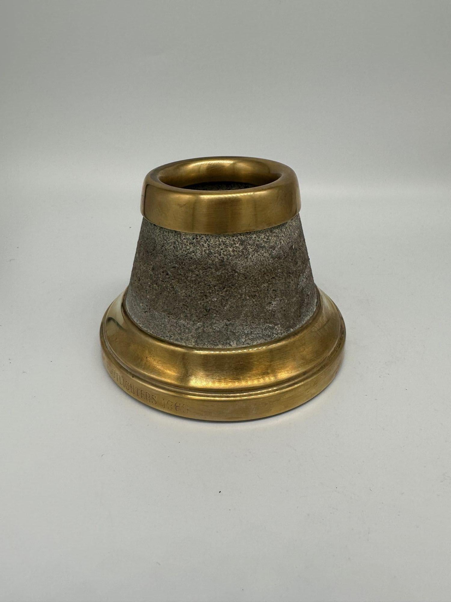 This Stone and Brass Match Holder and Striker, signed 