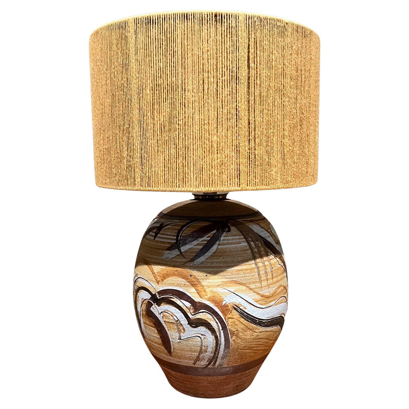 Studio Art Large earthenware pottery Table Lamp.
signed with maker initial at bottom section of lamp.
21.5 h x 13.5 diameter
New socket, new wire, new plug. No lamp shade or harp is included.
Preowned vintage condition
Refer to images listed
