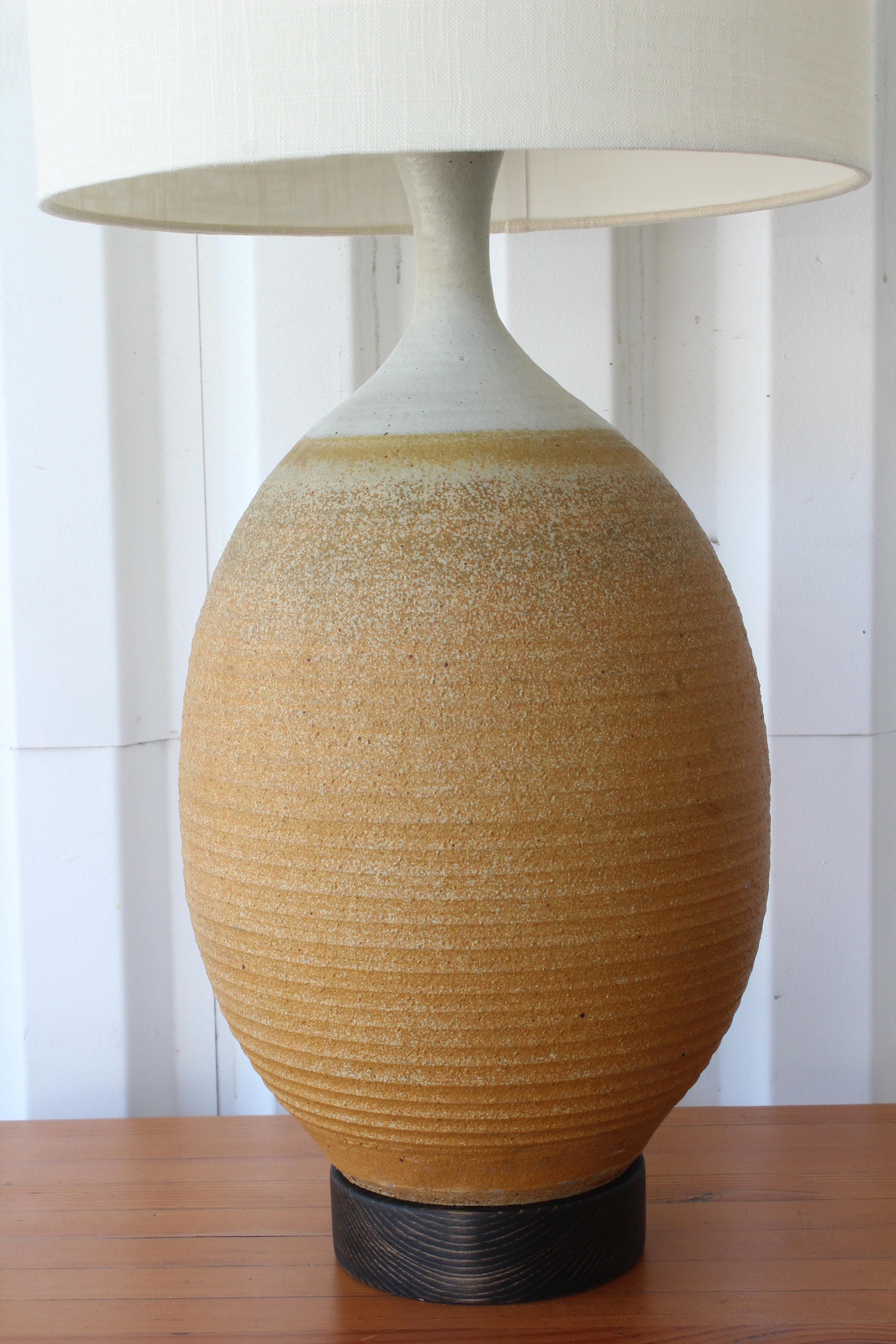 Vintage stoneware pottery lamp. Newly rewired with a new custom made shade in Belgian linen. Measures: 35