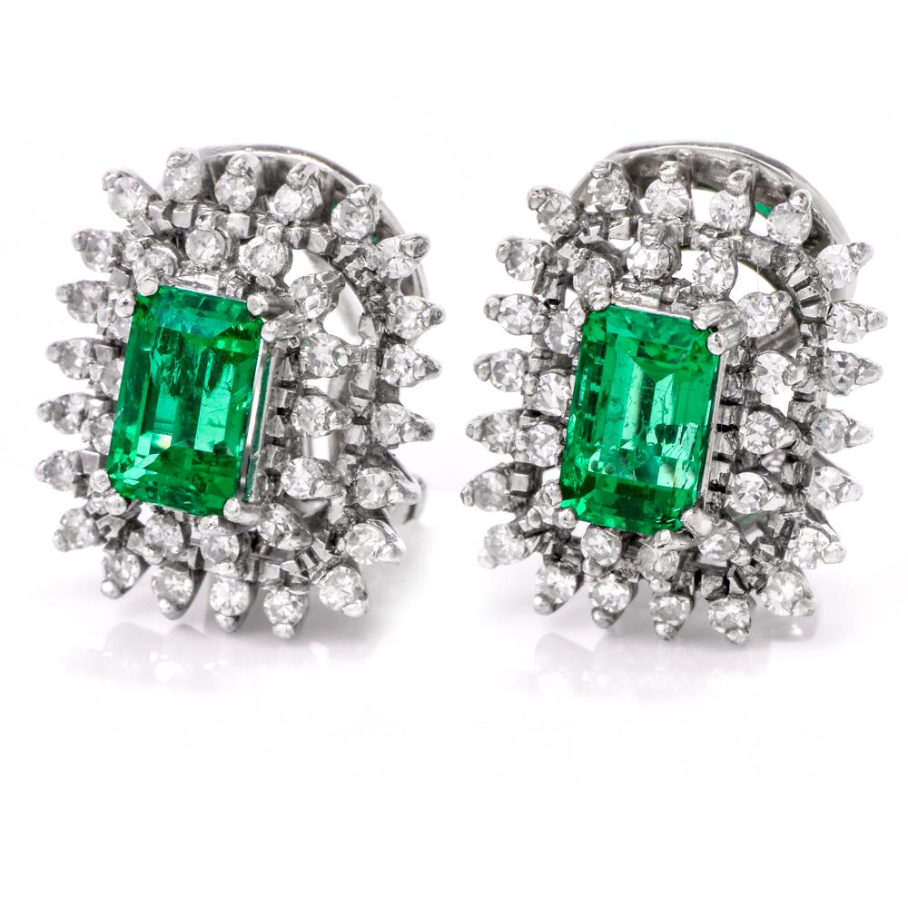 These vintage earrings crafted in 18-Karat white gold expose a pair of emerald-cut emeralds Positioned in elevated position surrounded by two diamond borders placed in two distinct layers. 

The high quality Colombian translucent emeralds