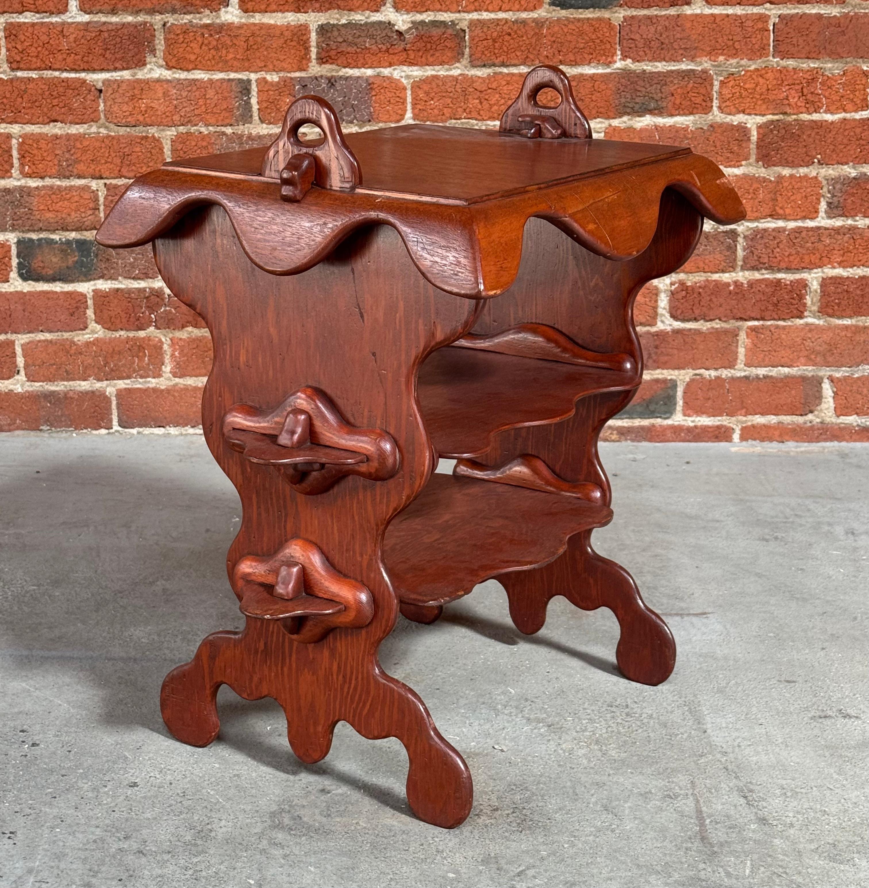 Plywood and solid mahogany studio craft made three tier side circa late 1960s to early 1970s. The aesthetic is of the Art Nouveau and Antoni Gaudi school which had a resurgence during this timeframe. The sides are constructed of a thin hand formed