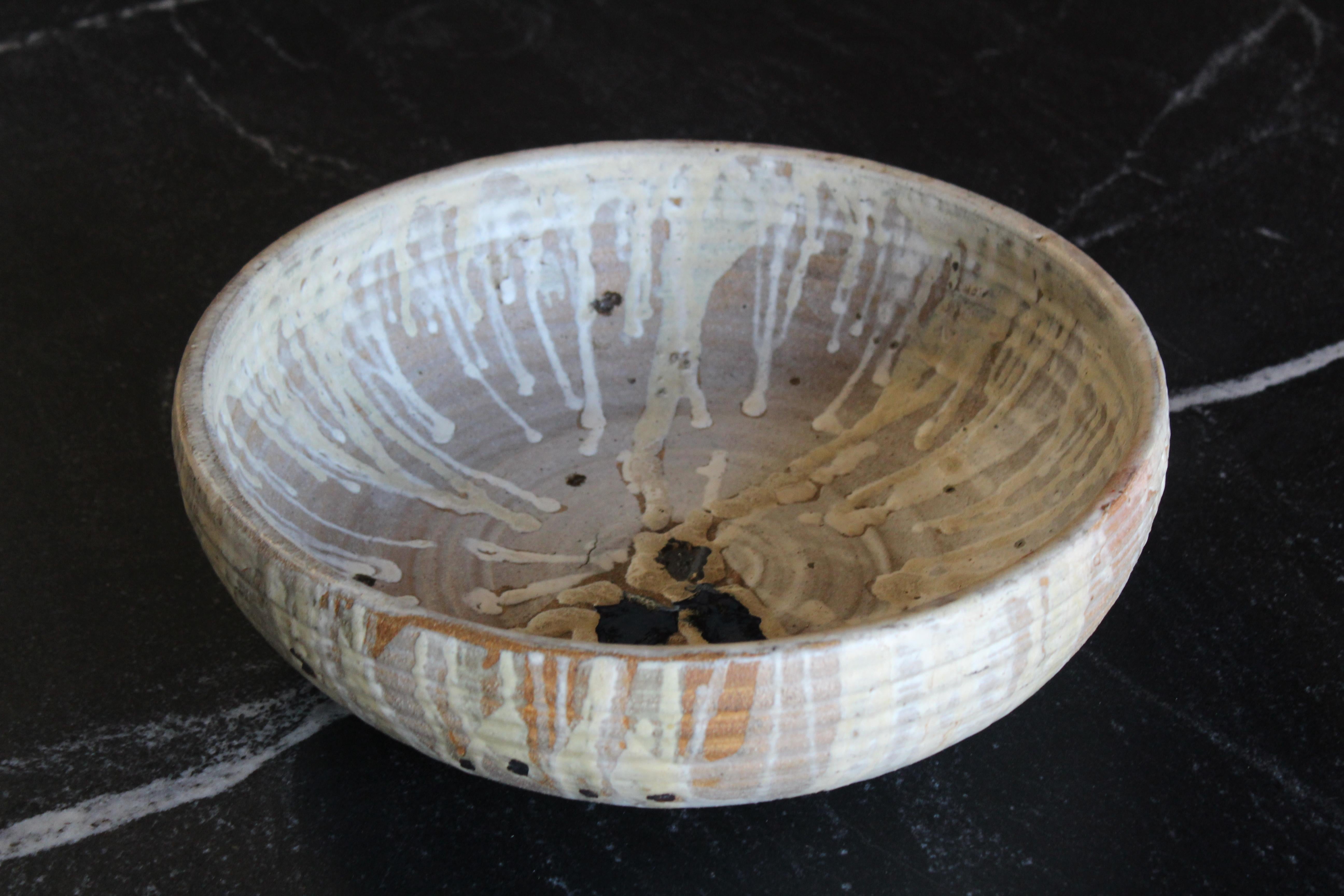 A vintage 1960s era studio pottery bowl made of stoneware with a drip glaze. Signed 'Maddox'. In excellent condition.