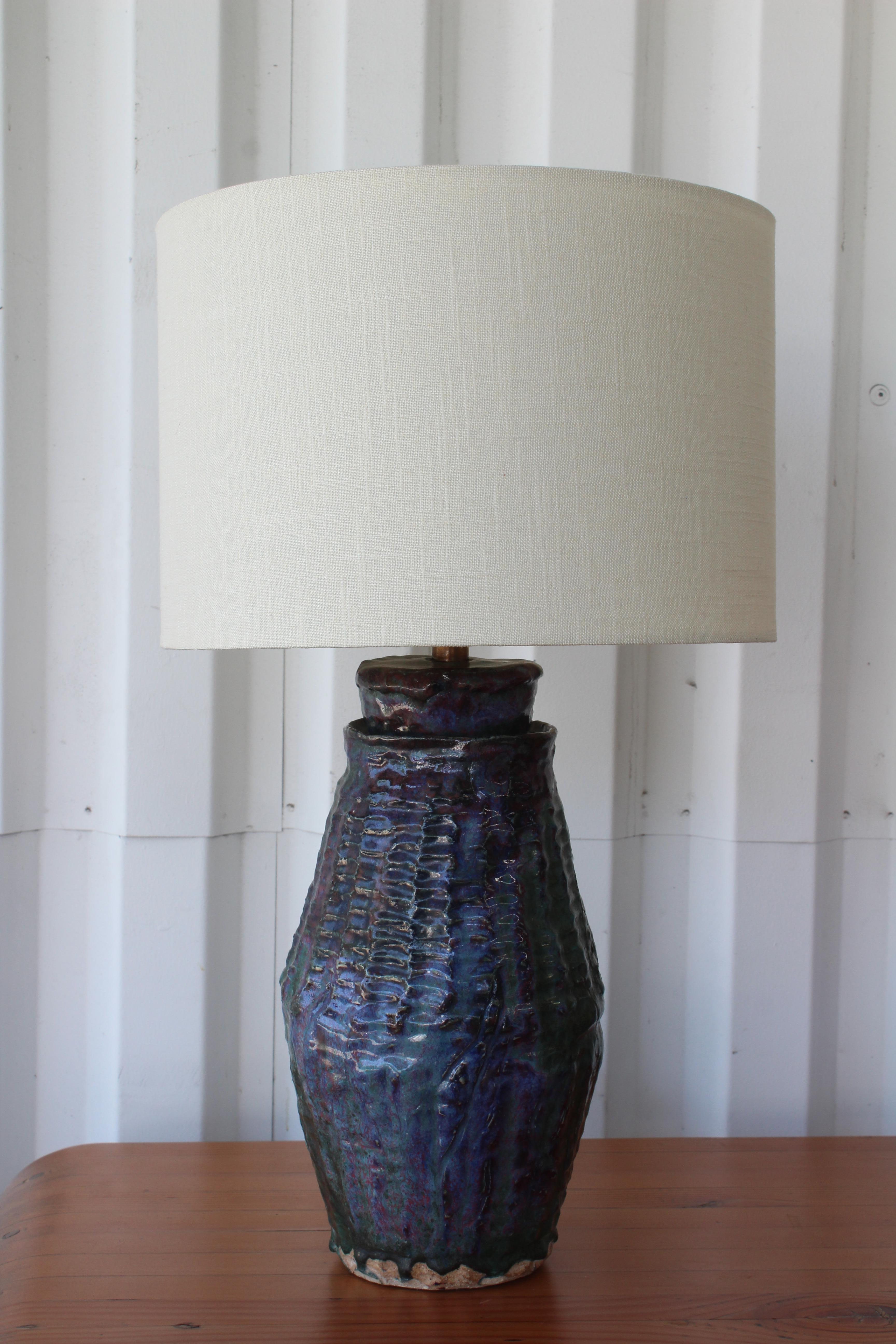 Vintage 1960s studio pottery lamp in a purple and blue glaze. Newly rewired and new custom shade in Belgian linen. 24