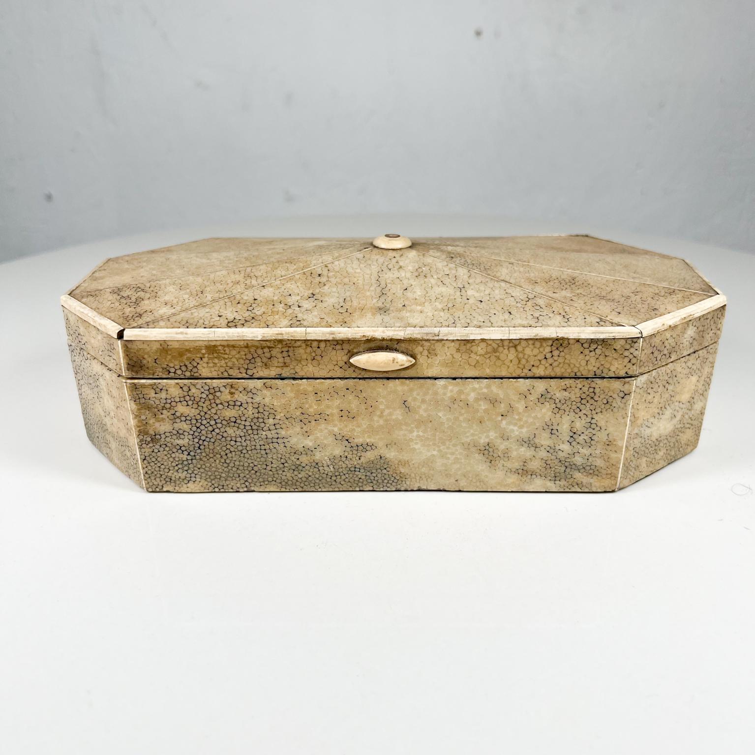 1930s Art Deco elegance Shagreen Trinket Keepsake Box Stingray Leather Wood interior
8.5 w x 3.88 d x 2.75 tall
Fabulous design in the style of Jean Michel Frank.
No label present.
Original preowned vintage condition. Some trim on edge missing.