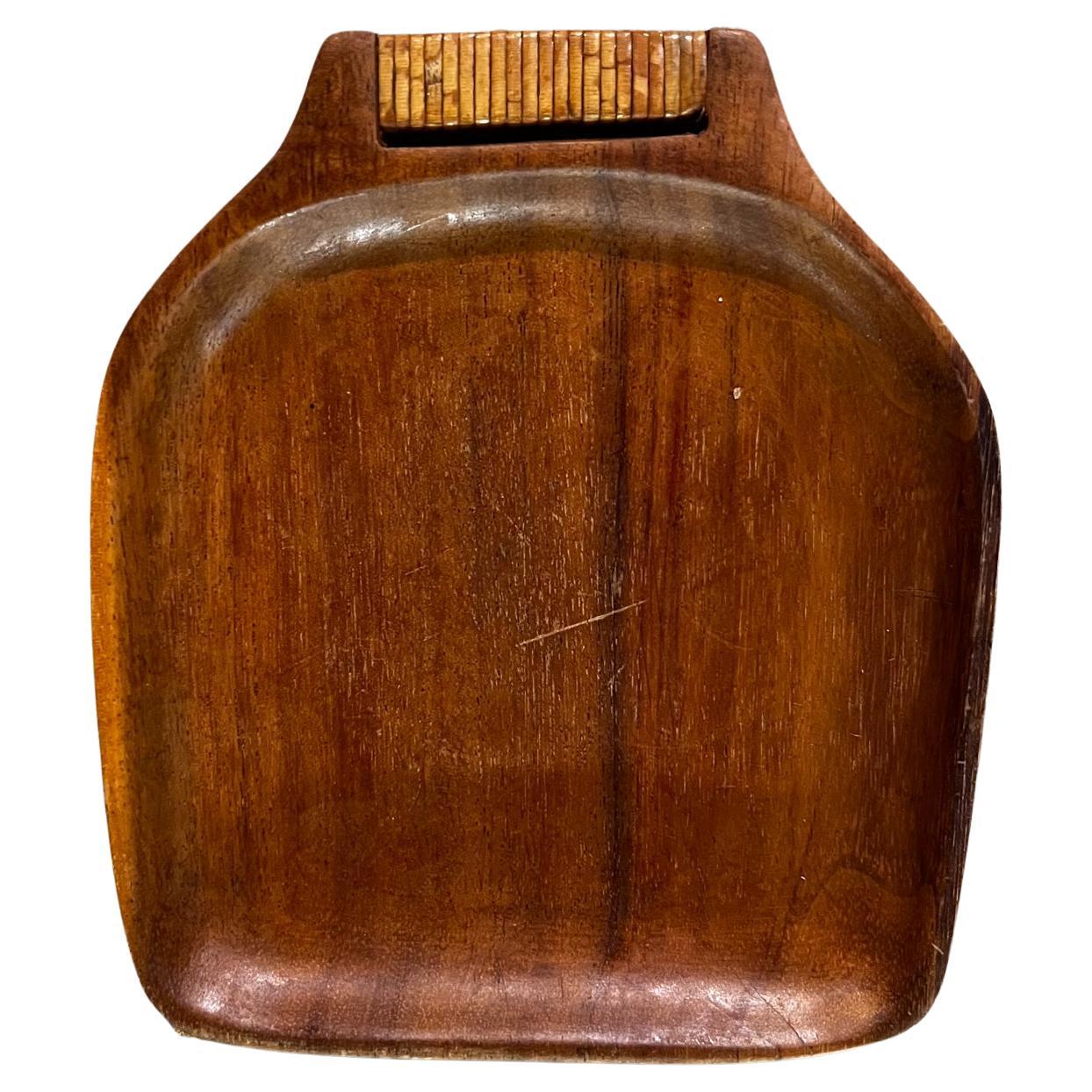 1960s stylish Modern Teakwood Tray with Cane Wrapped Handle
Appears to be teak wood. 
Unmarked.
Measures: 7.13 depth x 6.25 width x .75 thick
Preowned vintage condition.
Refer to images provided please.


