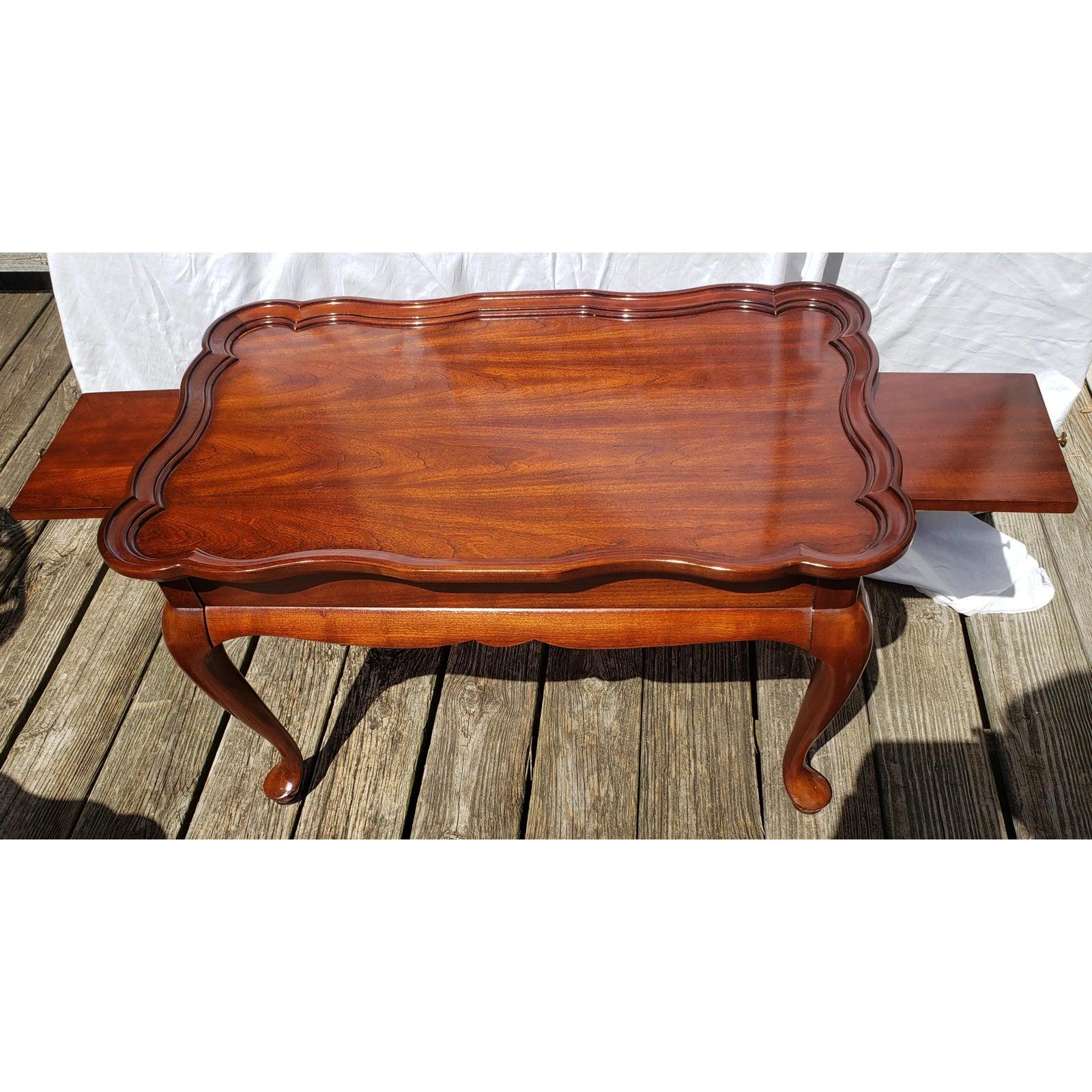 Superior Furniture Mid-Century Modern solid walnut coffee table with scallop edge and pull out trays. 30W x 18D x 18.75H. 7