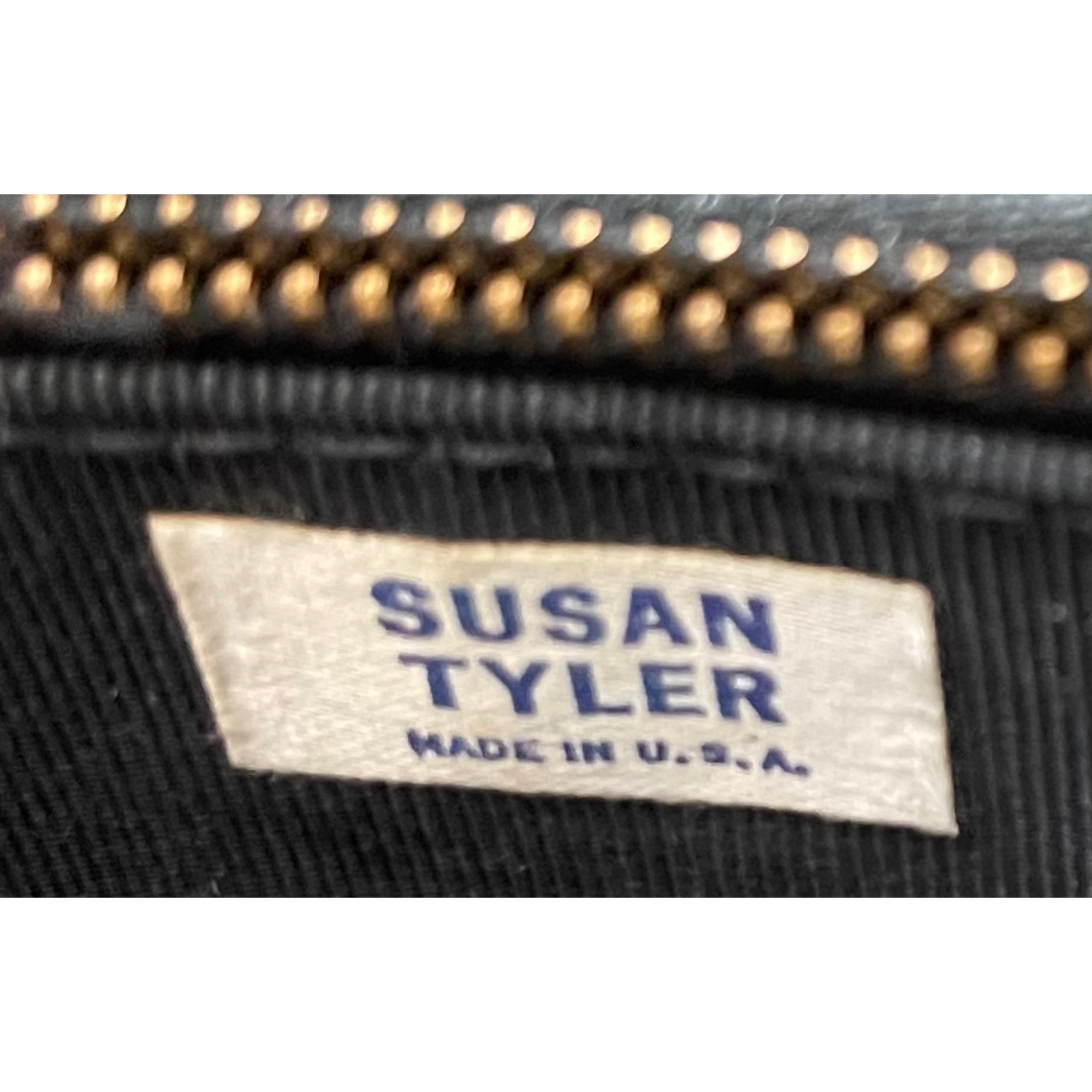 Chic 1960s SUSAN TYLER black patent leather handbag ! This bag has it all—there are three different separate pouches attached to one another. Zipper pocket in the last pouch. Snaps closed. Gold top handle has a lion head on each side. Can fit so