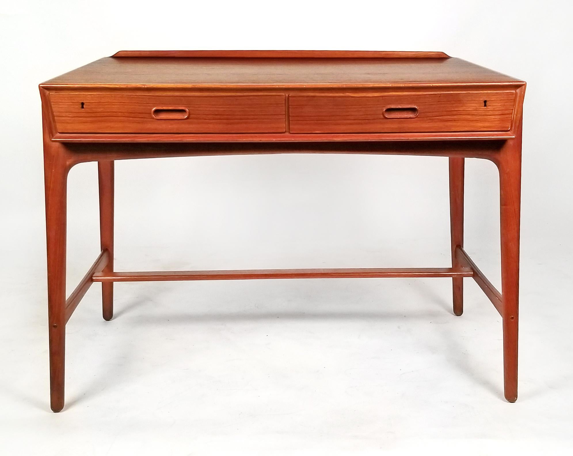 This beautiful little teak desk was designed by Svend Age Madsen and was crafted by the Scandinavian cabinet makers at Sigurd Hansen. The proportions are design details are amazing from the slightly forward sloping writing surface to the tapered