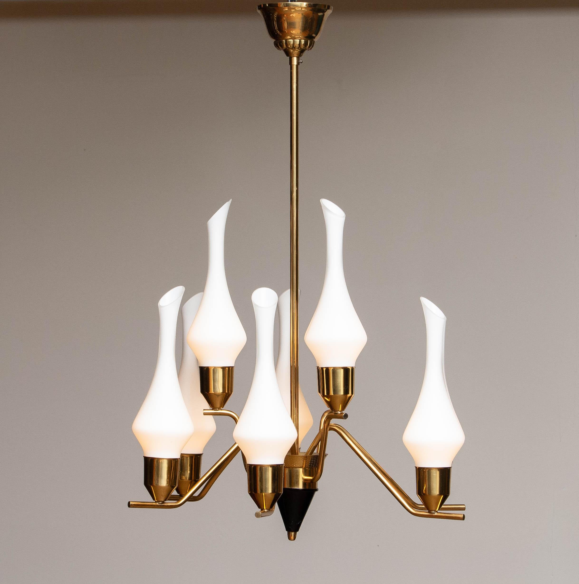 Beautiful designed high quality nine-arm chandelier in brass with nine slim organic white frosted glass vases attributed to Hans Bergström and ASEA in Sweden.
The upper and lower arms can be separately switched on / off. Technically 100% and