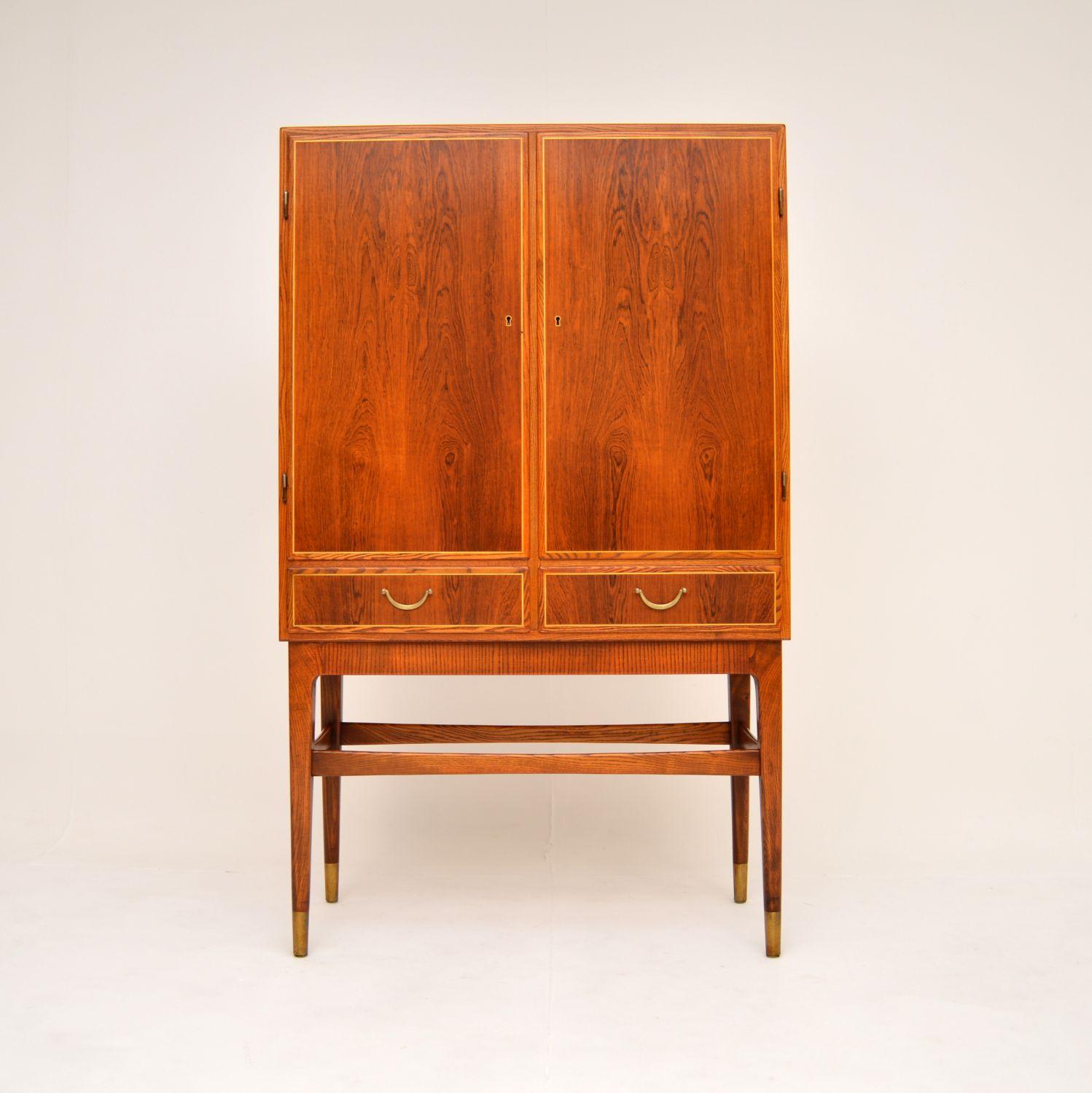 An absolutely stunning Swedish vintage cabinet. This was made by Nordiska in the 1960’s, it was recently imported from Sweden.

The quality is exceptional, this has a beautiful design, with amazing brass inlays around the door and drawers fronts.