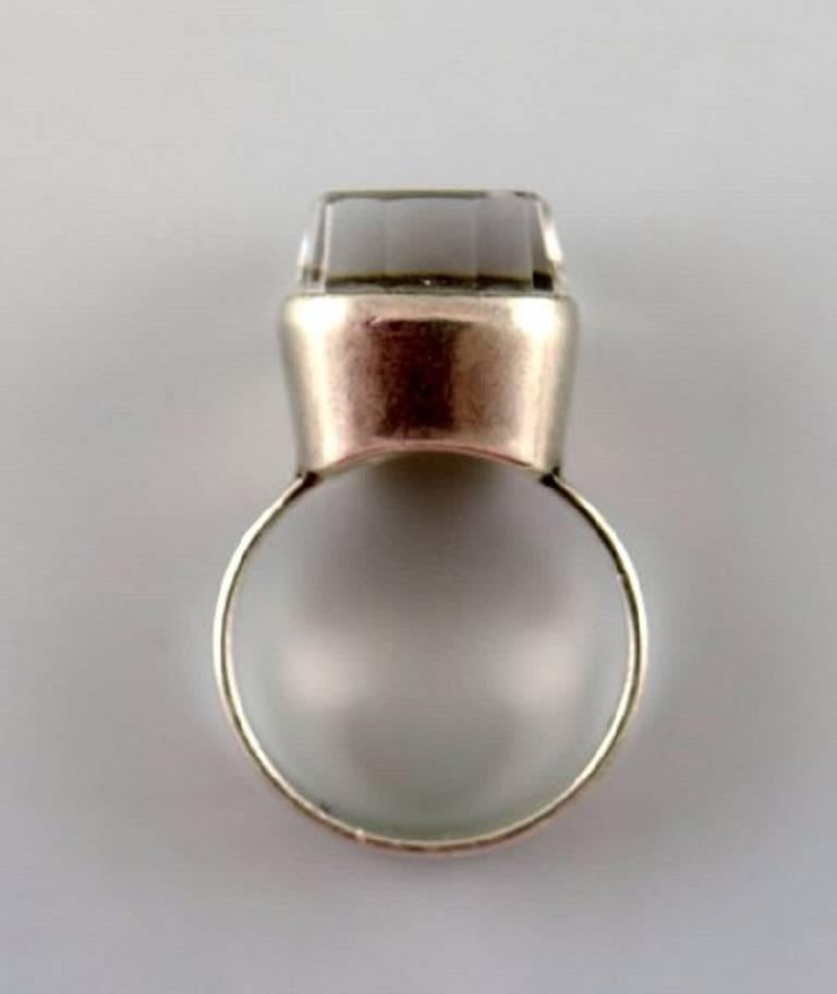 Swedish modernist silver ring with mountain crystal.
Size: 17 mm. US Size 6-7. Our silversmith can adjust to any size for an additional $50.
Stamped: 835. 
1960s.
In very good condition.
LARGE SELECTION OF modernist SILVER FROM 1960/70 IN STOCK