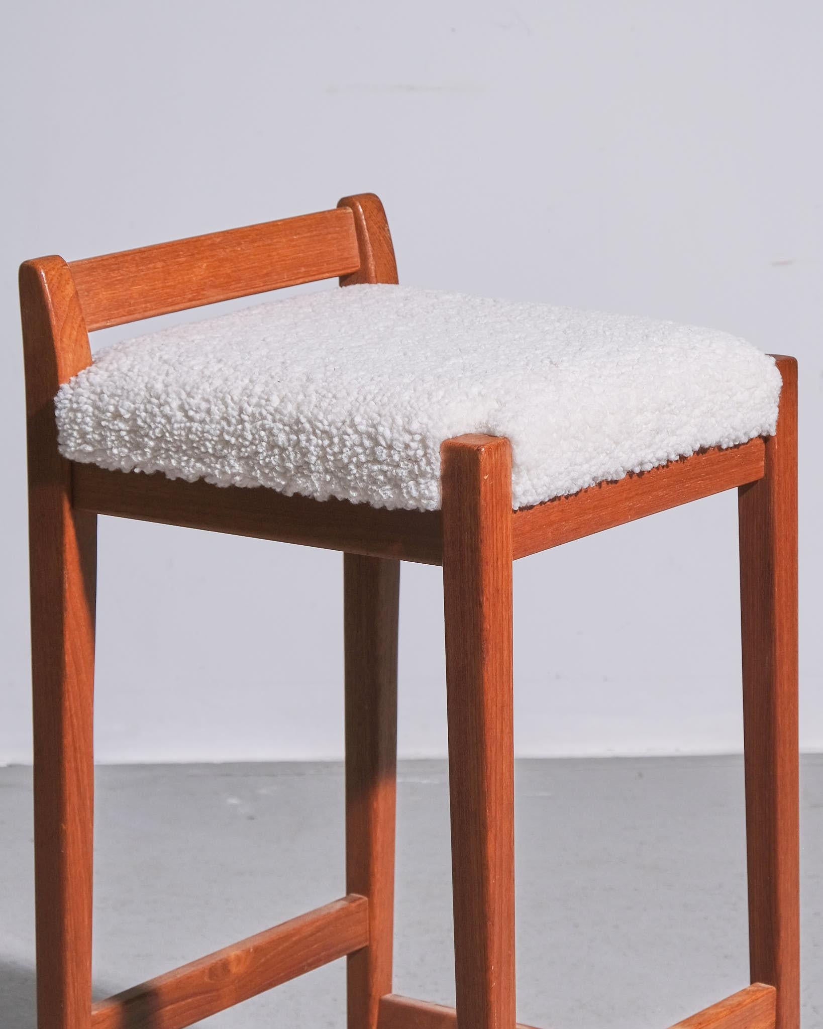 A vintage Swedish bar stool from the 1960s, crafted from solid teak with a simple yet refined design. The stool features a sturdy teak frame with elegantly tapered legs and a well-proportioned seat. The seat has been professionally reupholstered in