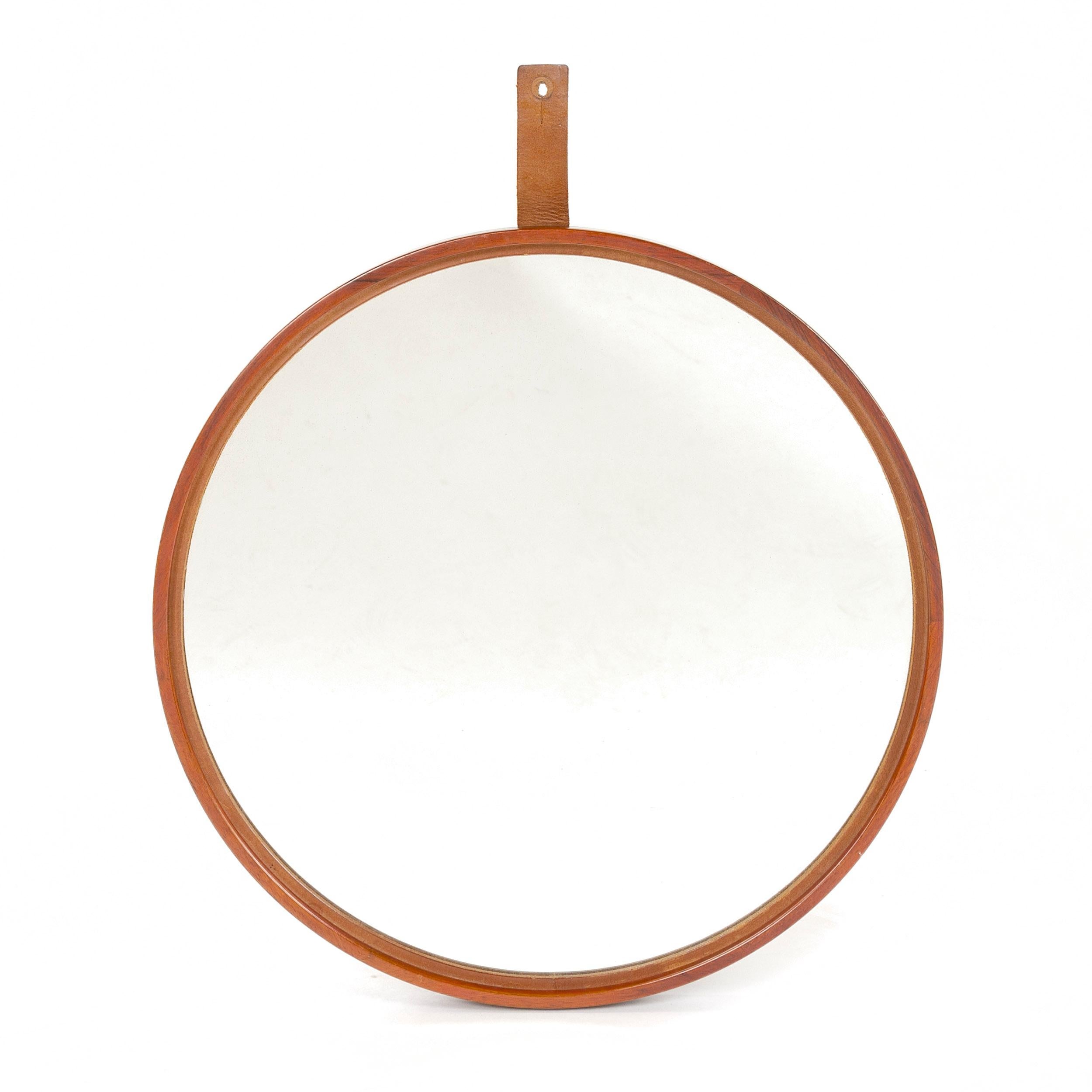 Finely crafted circular mirror set in a narrow teak frame with leather hanging strap.