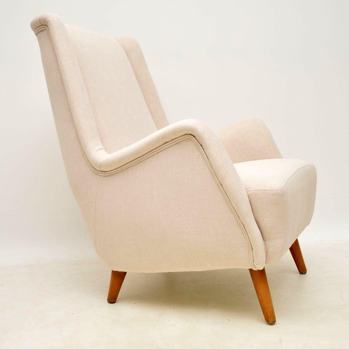 A beautifully made, stylish and very comfortable vintage armchair, this was made in Sweden during the 1960s, it was designed by Alf Svensson. It has a lovely shape and sits on very solid splayed beech legs. We have had this fully re-upholstered in a