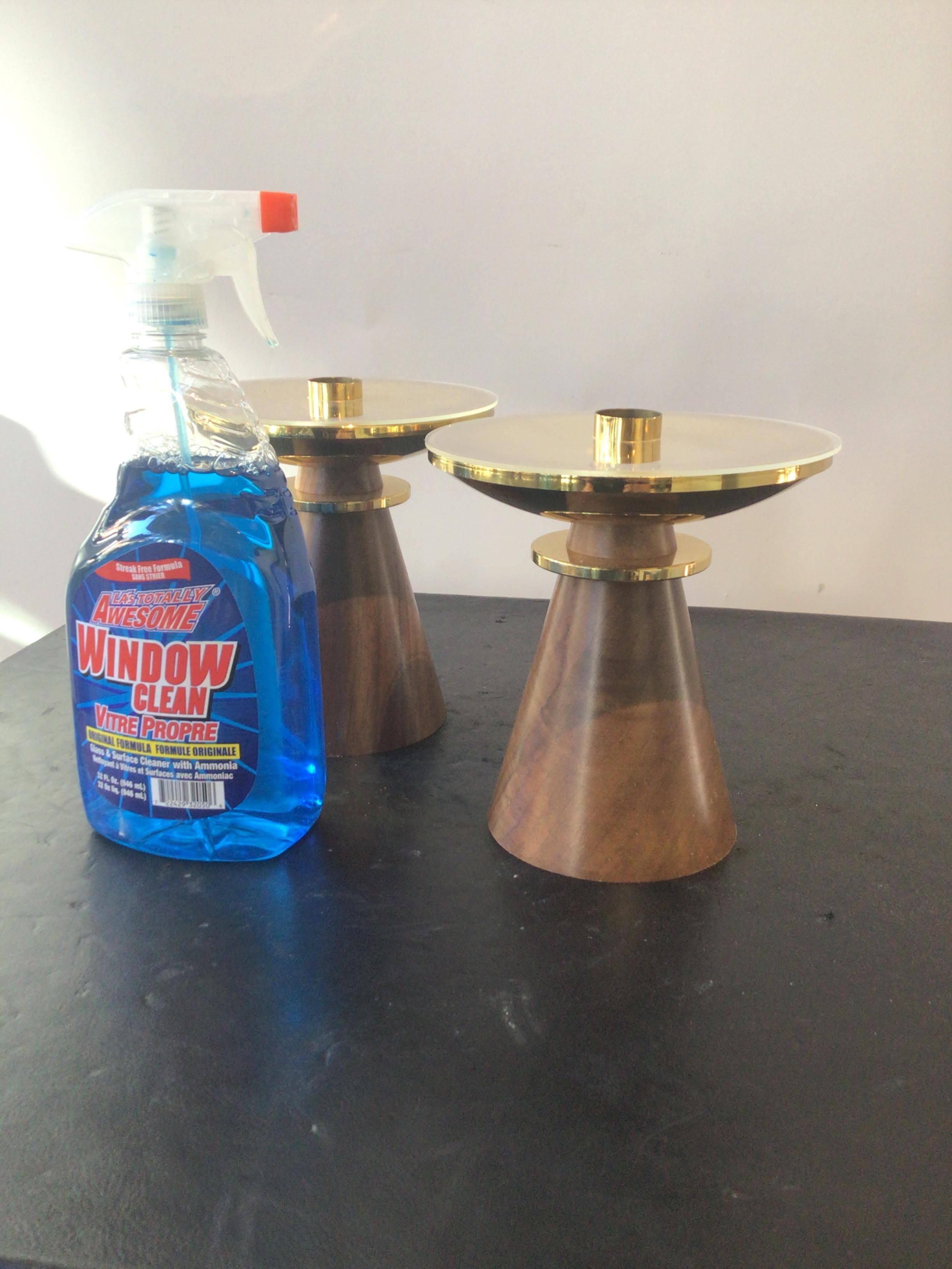Pair of 1960s brass and walnut Swiss candlesticks. Beautiful design. Purchased from a Scarsdale, NY estate. The owner was a manufacturer of these candlesticks in Switzerland, and imported them into the states in 1964.