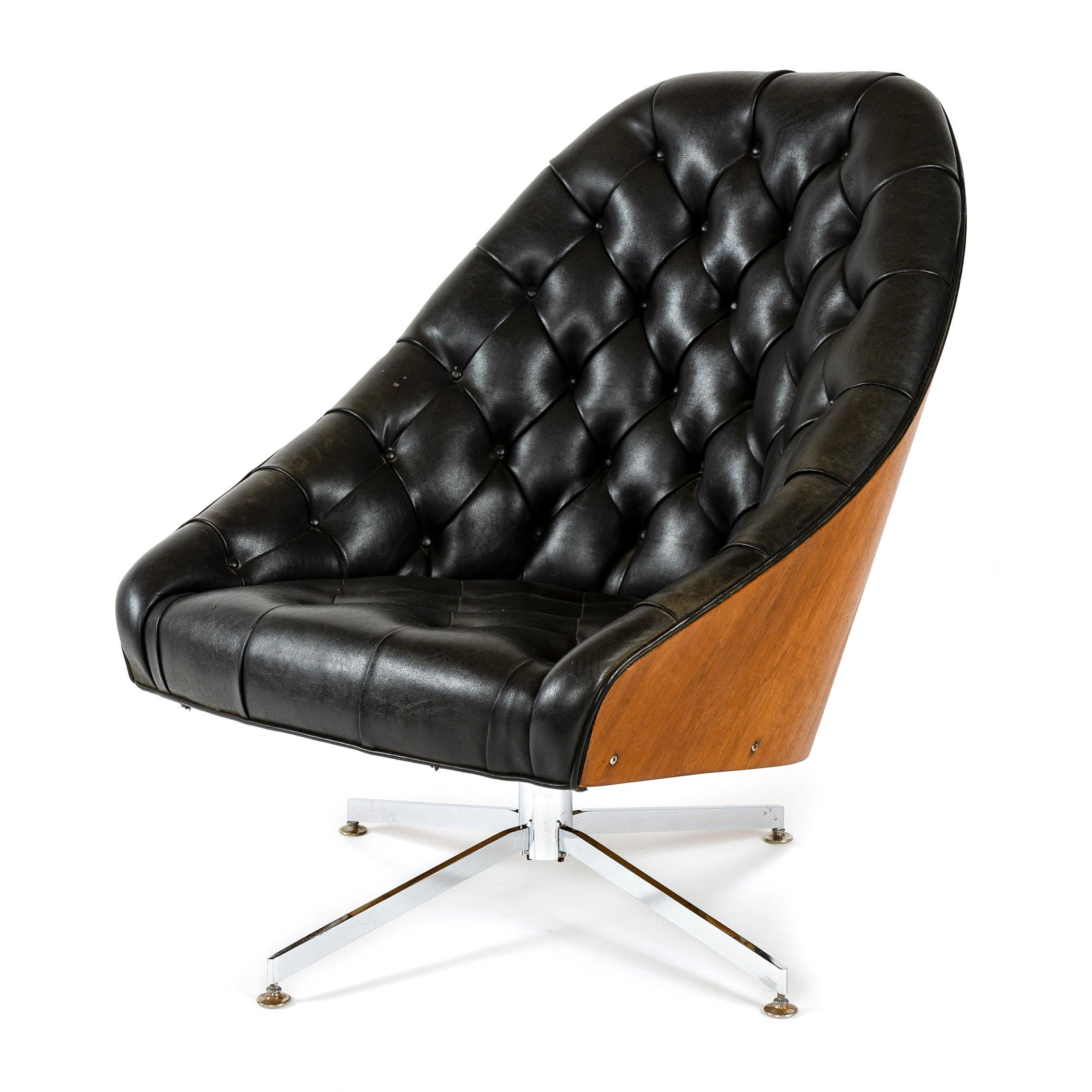 A tufted lounge chair with wrap around walnut back set on a bright chrome, reclining pedestal swivel base.