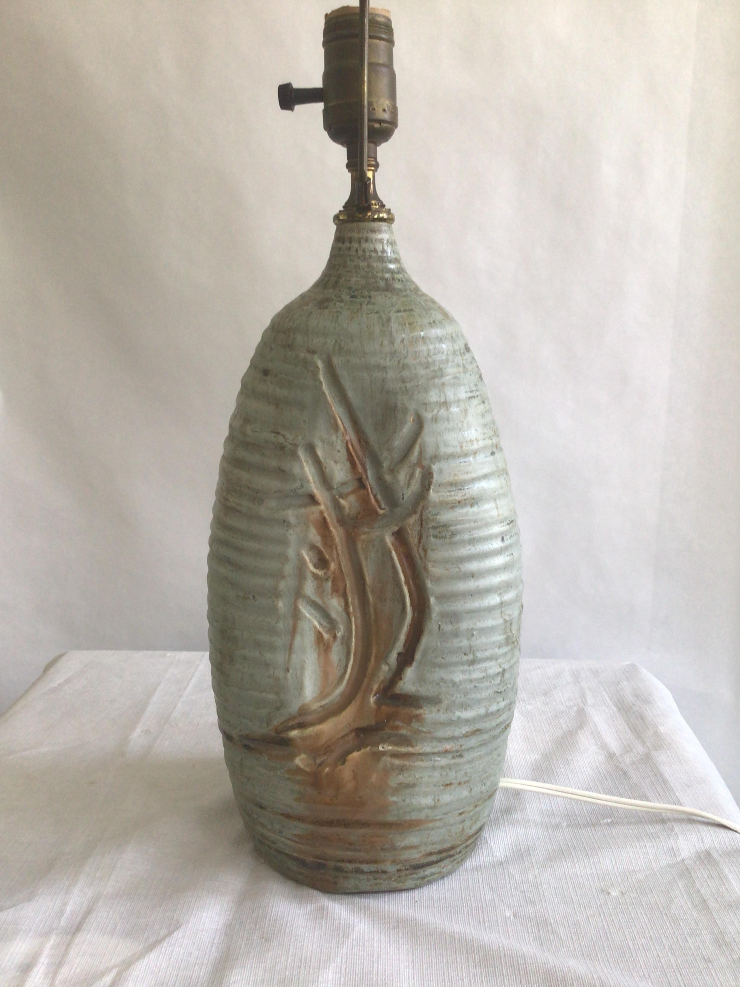 This 1960 Table Lamp with Hand Carved Wheat Motif in an ovoid shape has a cylindrical neck resembling that of a bottle
The lamp is finished in neutral beige hues with carved decoration executed in a deeper shade of brown or rust
Height to top of