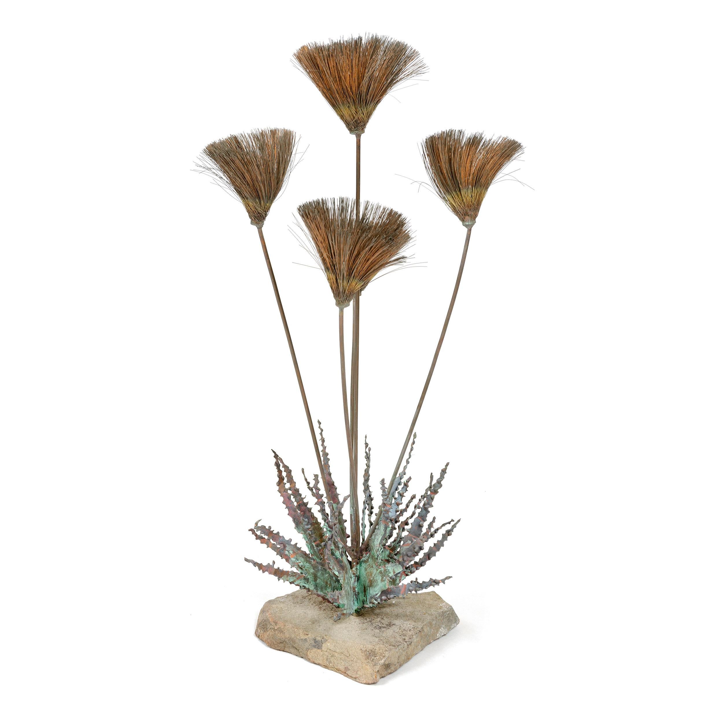 From Steck’s 'Desert Flower’ series, this tabletop sculpture exhibits, per an America House advertisement in Craft Horizons January/February 1965 (which illustrates this sculpture), “sizzle blooms of burnished copper on long-stemmed bronze and a