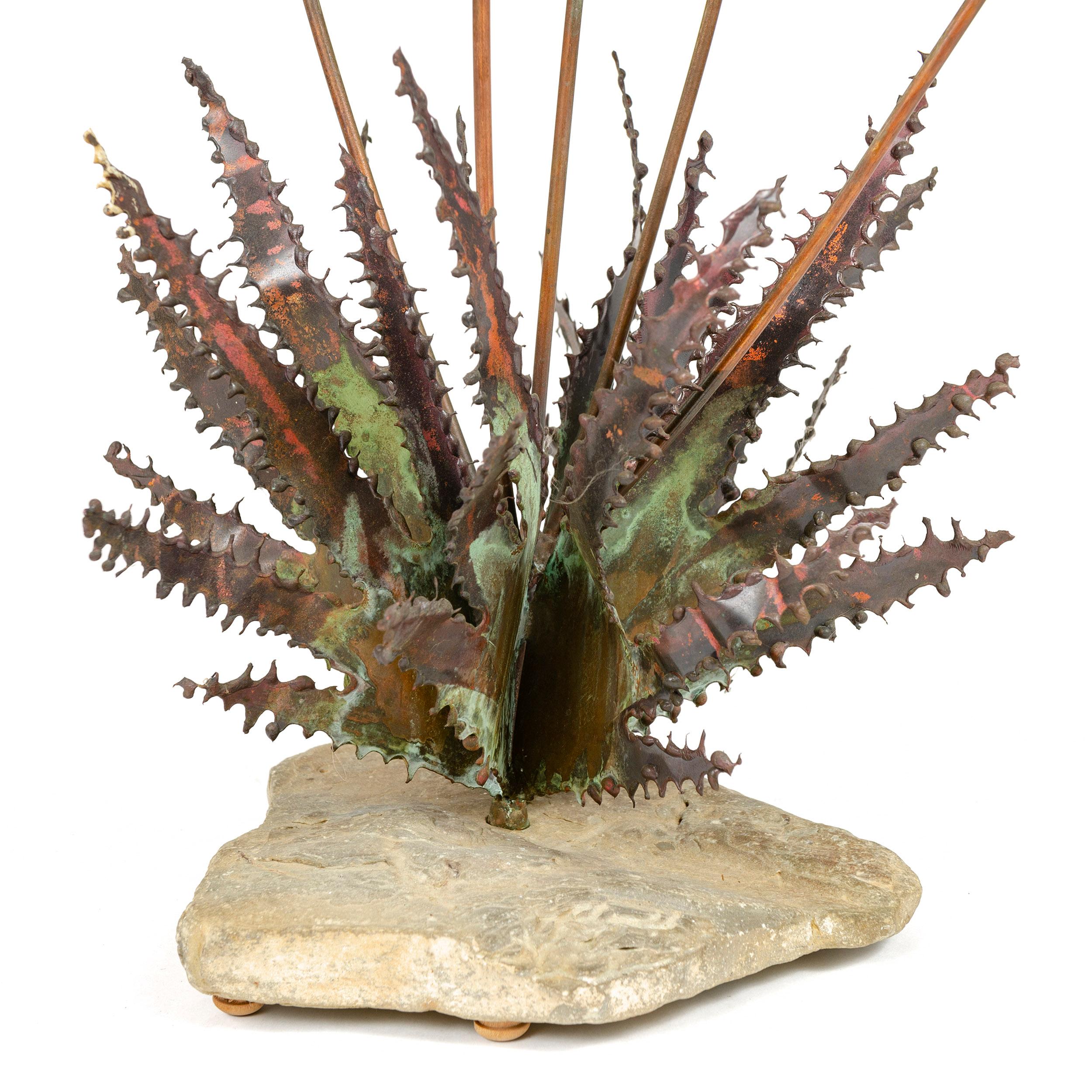 From Steck’s 'Desert Flower’ series, this table top sculpture exhibits, per an America House advertisement in Craft Horizons January/February 1965 (which illustrates this sculpture), “sizzle blooms of burnished copper on long-stemmed bronze and a