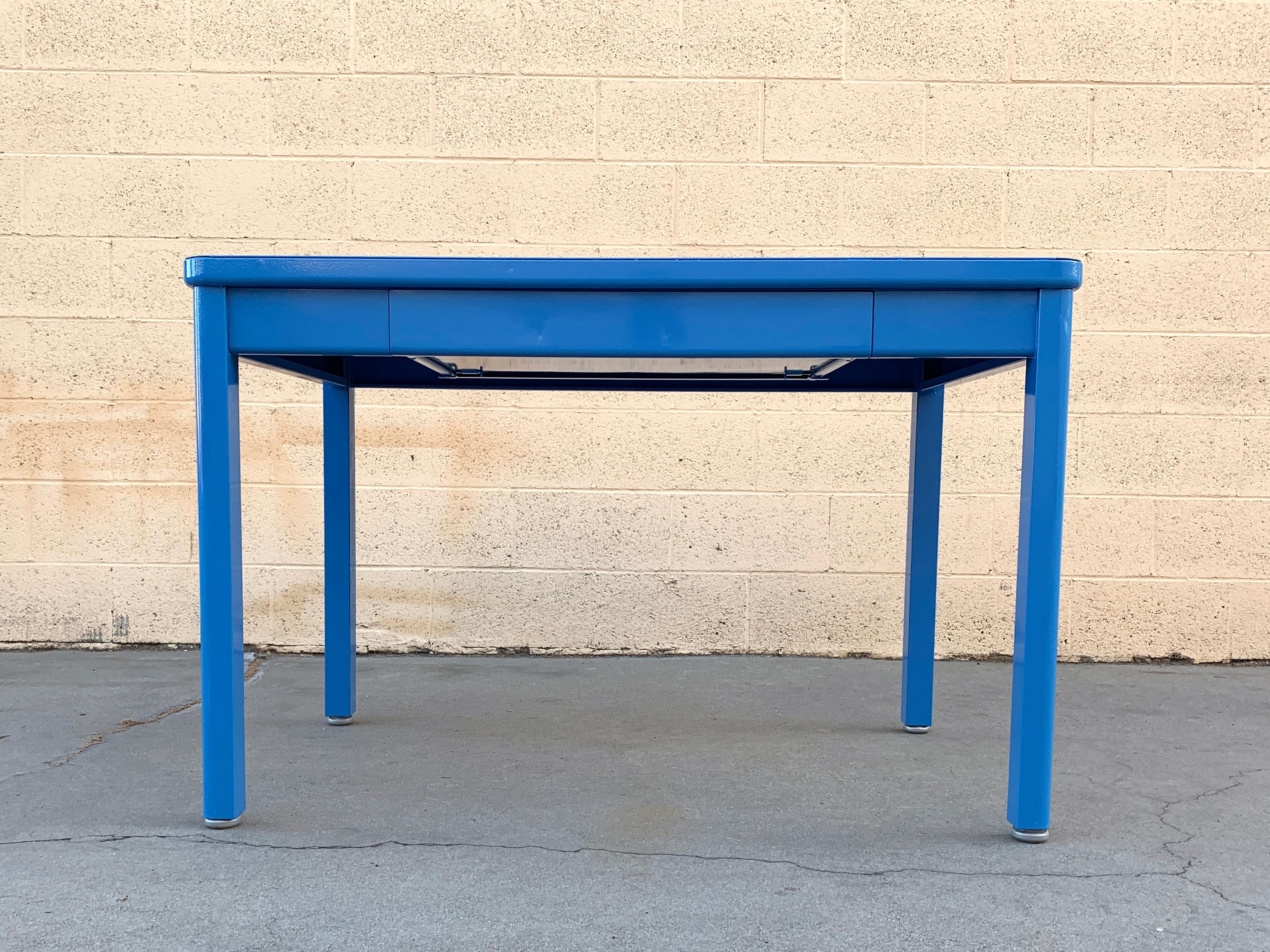 Midcentury Steelcase 4-legged table with drawer refinished in a powder coated pop of bright blue (RAL5012). This streamlined and practical tanker table is ideal in a workspace, office or library. Steel is in very good refinished vintage condition
