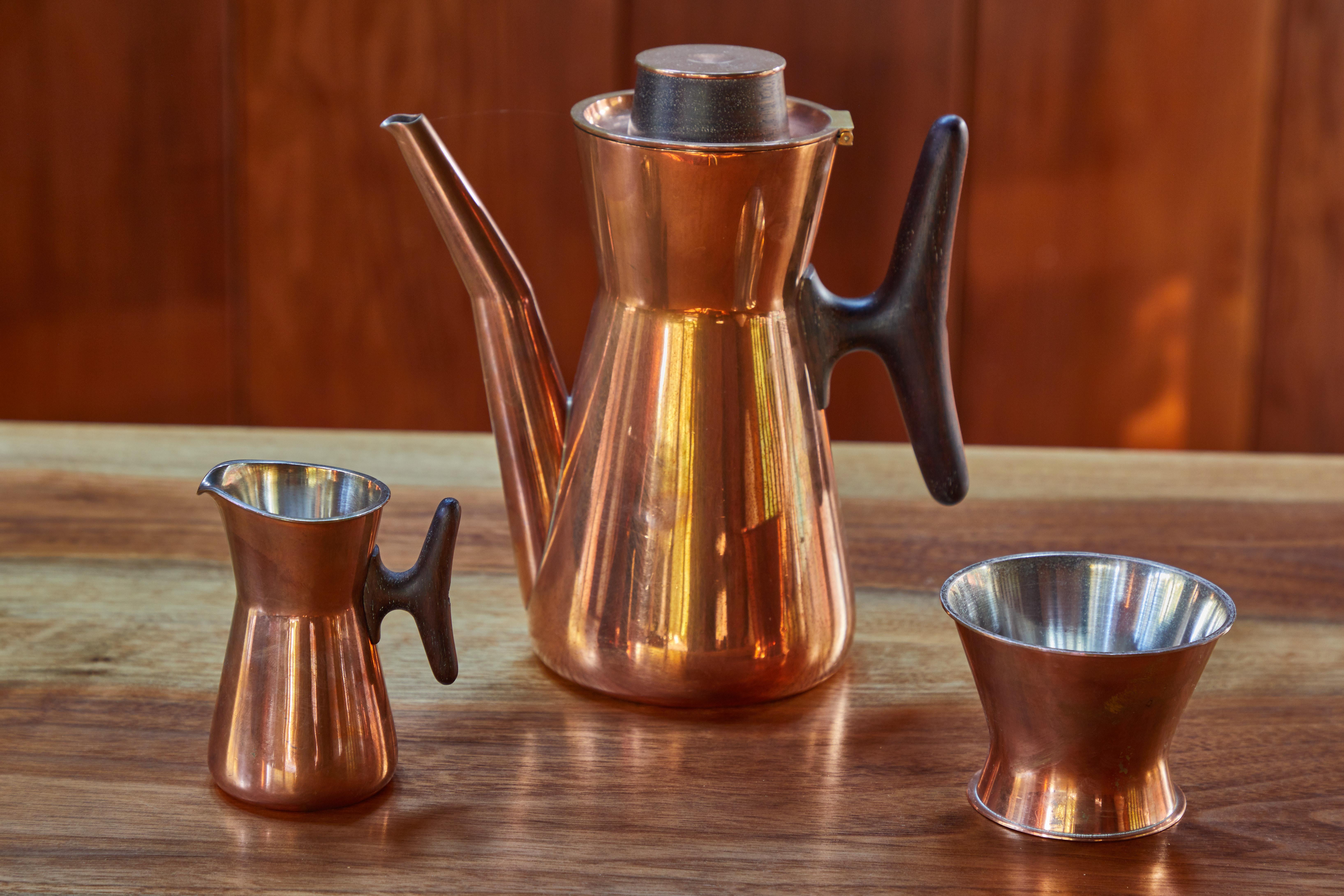 1960s Tapio Wirkkala copper and silver coffee set for Kultakeskus Oy. A solid copper coffee set including coffee pot, creamer, and sugar pot. Executed in copper lined in silver and hardwood (possibly rosewood) handles, these sets were handmade to