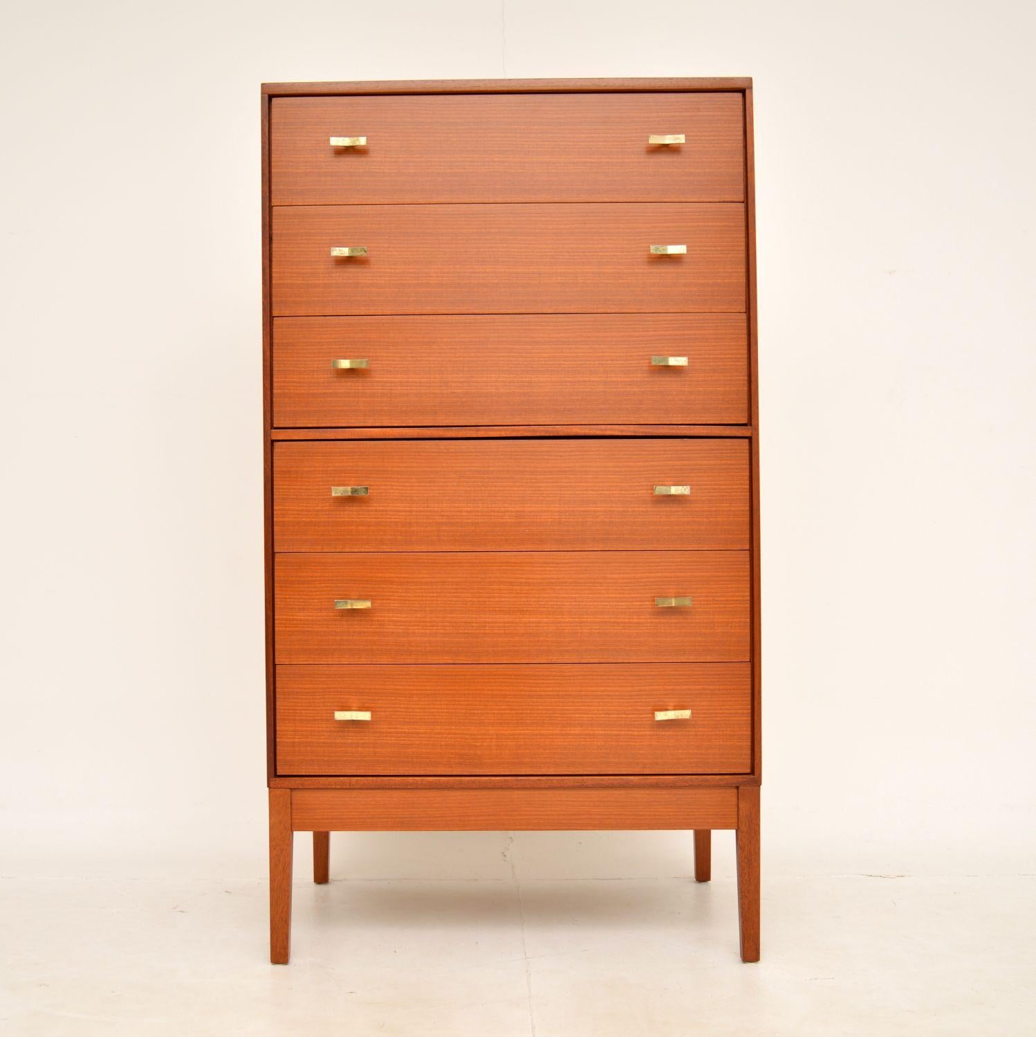 A beautiful and very well made vintage tallboy chest of drawers in teak and brass. This was made in England by Golden Key, it dates from the 1960’s.

The quality is excellent and this is a practical size as well as being very stylish. It is tall