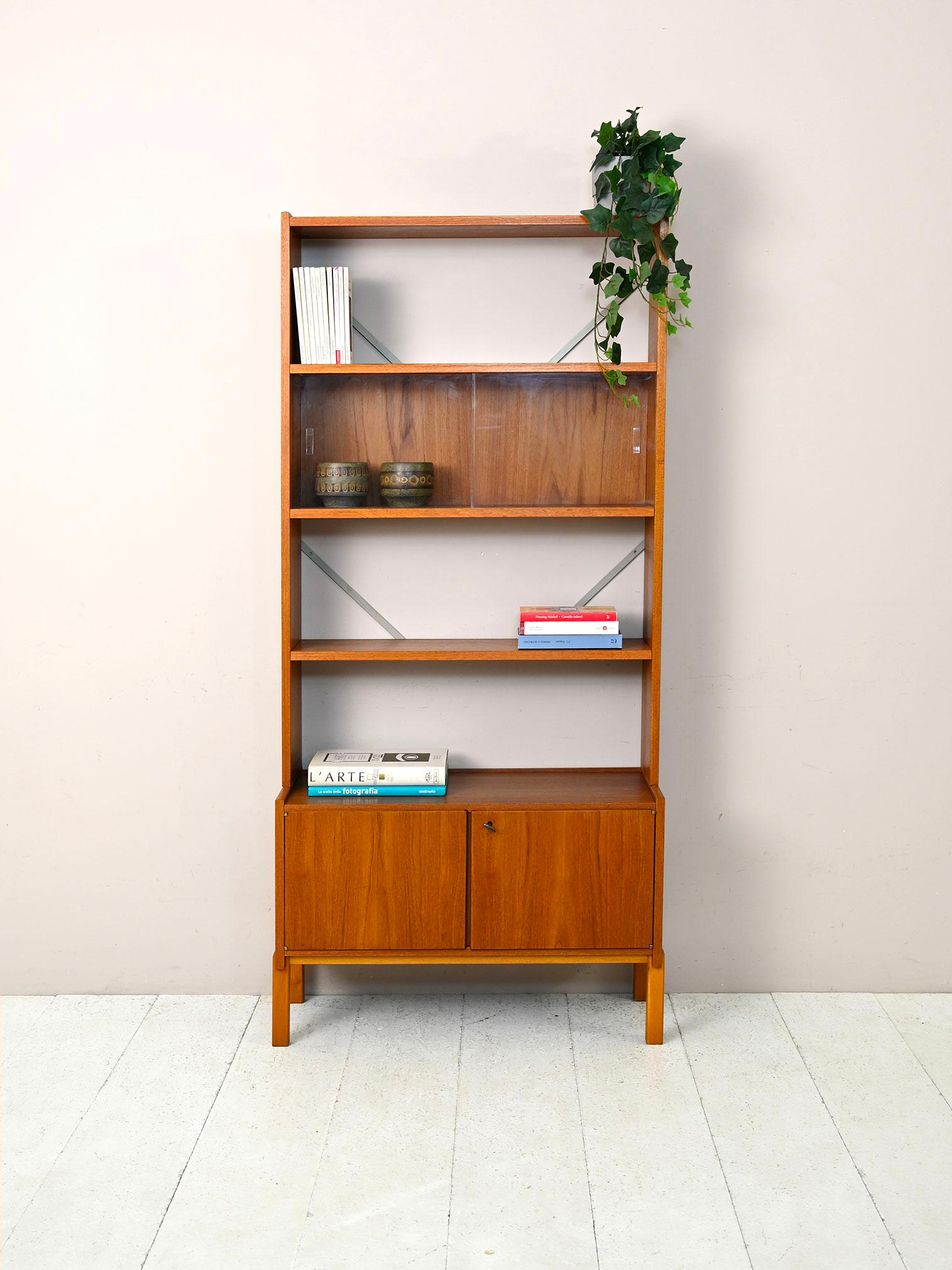 Scandinavian vintage bookcase.

Original piece of Scandinavian modern antique furniture consisting of two parts.  The low cabinet has two lockable hinged doors, and the upper part is a frame with two shelves and a hutch.
It can be used both as a