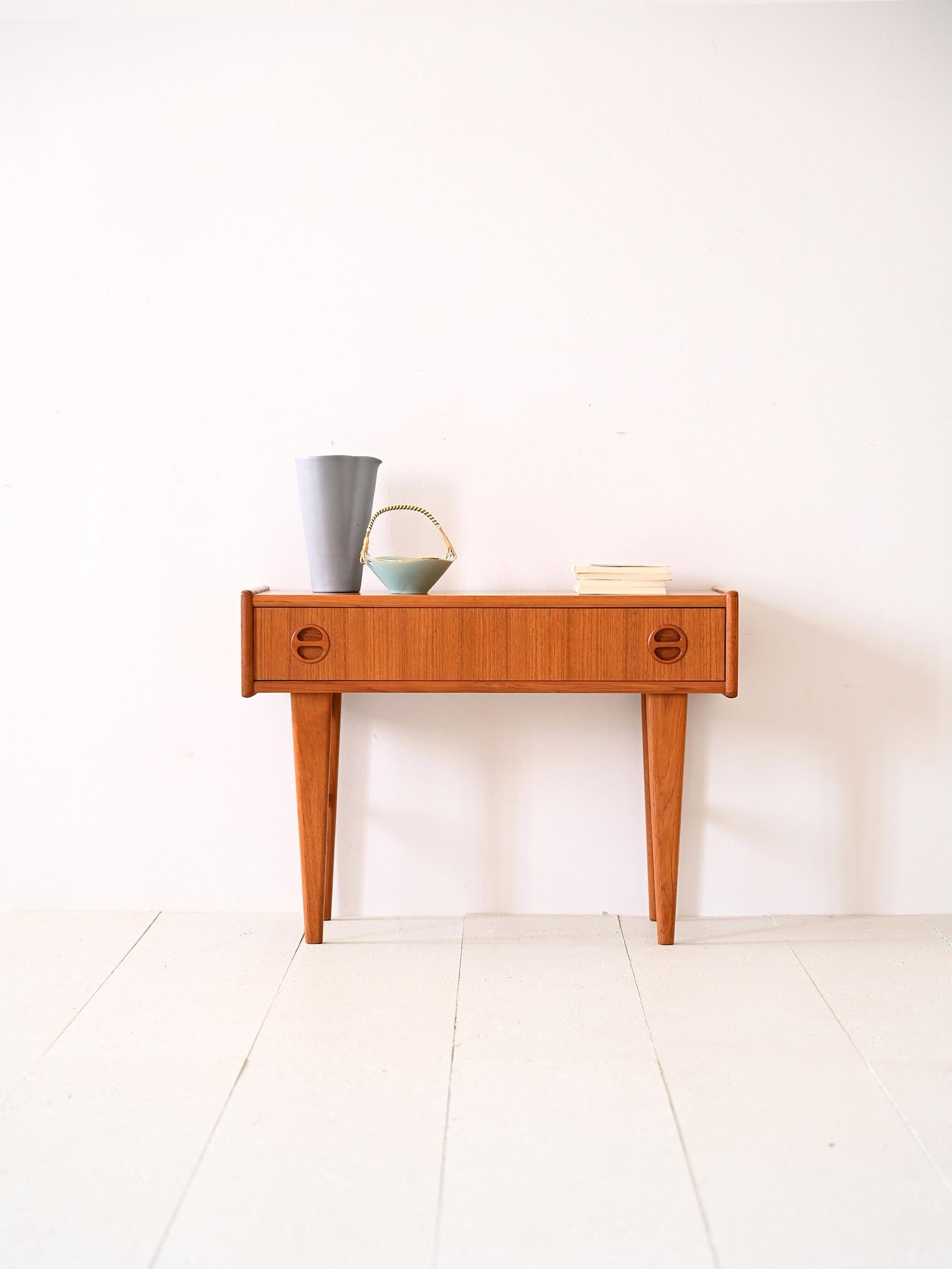 Table basse vintage avec tiroir.

Un meuble original qui peut également servir de table de chevet pour la chambre à coucher. Il se distingue par la forme rectangulaire de son plateau et le long tiroir qui se trouve en dessous. Les pieds coniques et