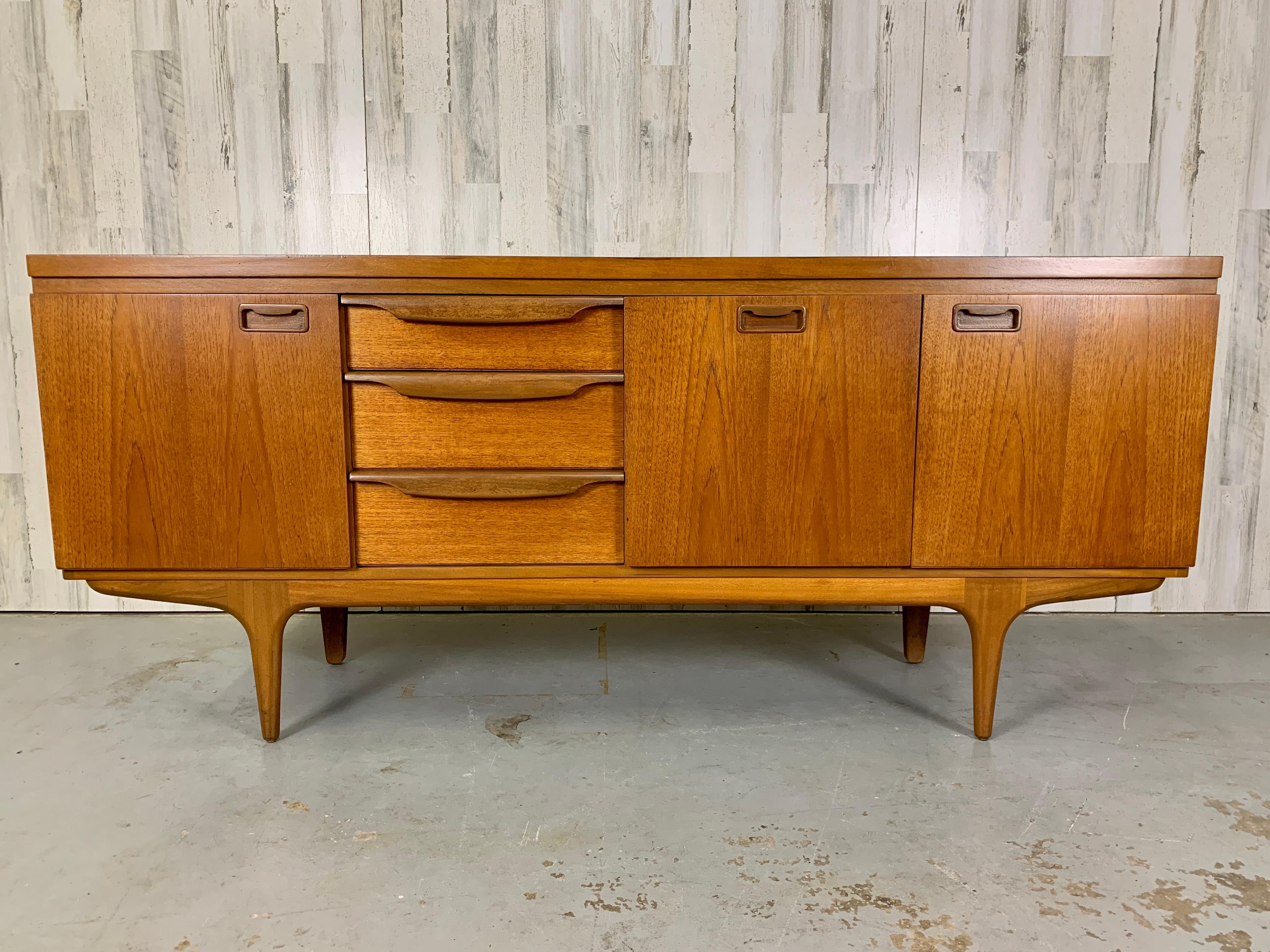 Beautiful teak credenza with a fold down bar area and plenty of additional storage.