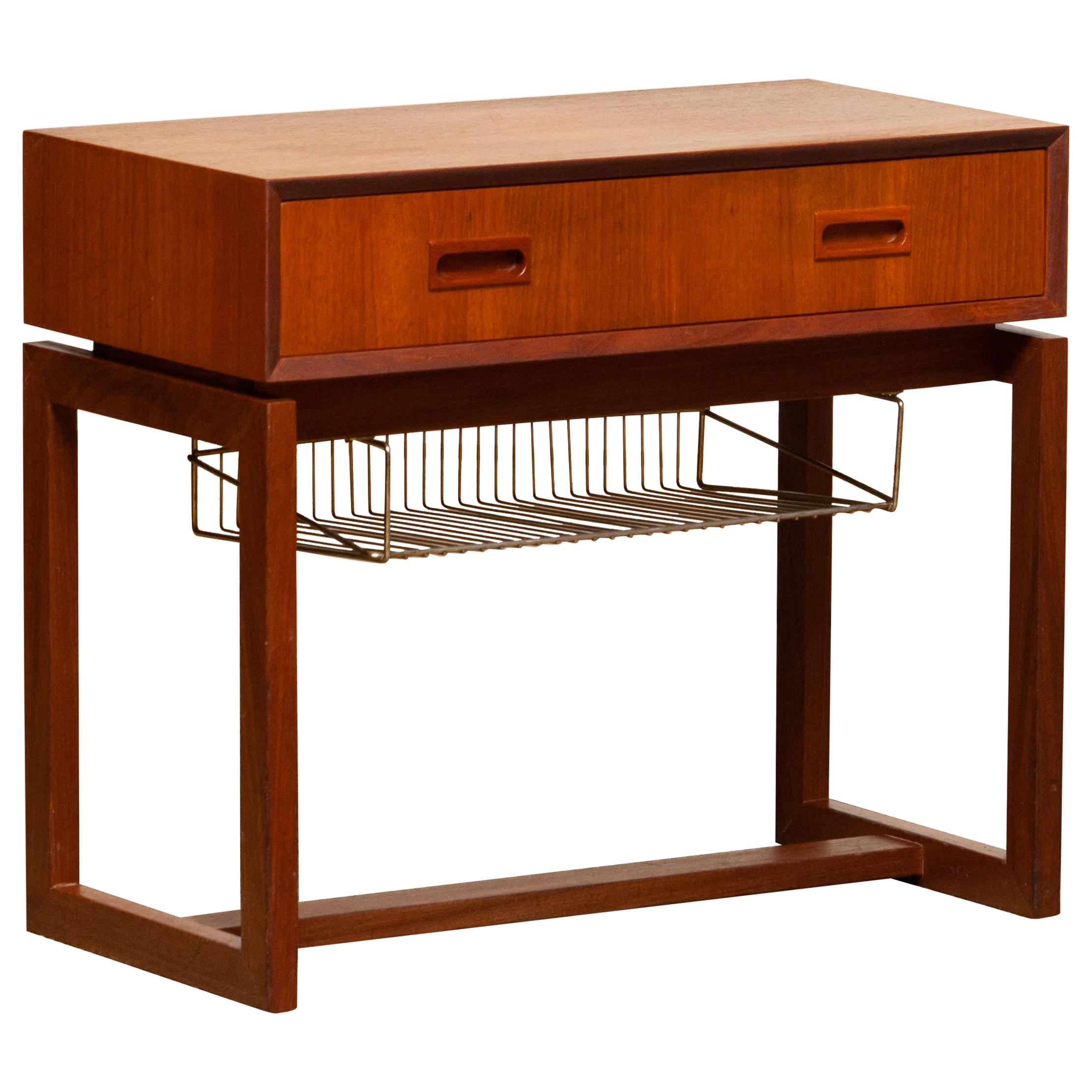 Beautiful teak side table / hall cabinet in teak consisting one drawer and a paper rack in brass. This side table is made in the '60s in Denmark and the overall condition is good.